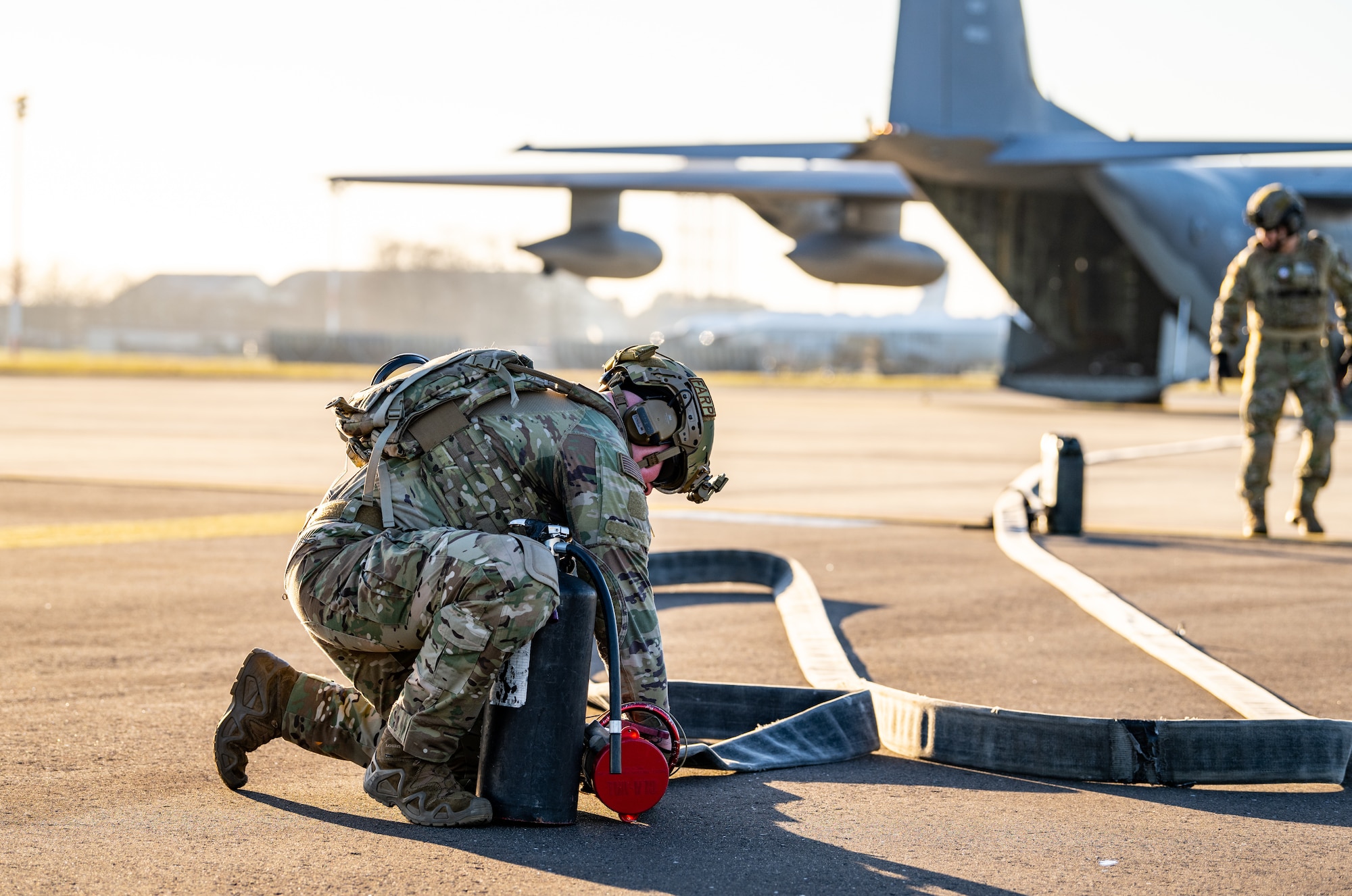 A 100th Logistics Readiness Squadron forward area refueling point (FARP) specialist assigned to the 100th Air Refueling Wing, works to secure a fuel hose during FARP training at Royal Air Force Mildenhall, England, Feb. 6, 2023. FARP capabilities enable the 100th ARW and the 352nd Special Operations Wing to partner together and provide critical on-the-ground refueling to NATO allies and European partners in austere locations with a minimal footprint. (U.S. Air Force photo by Staff Sgt. Kevin Long)