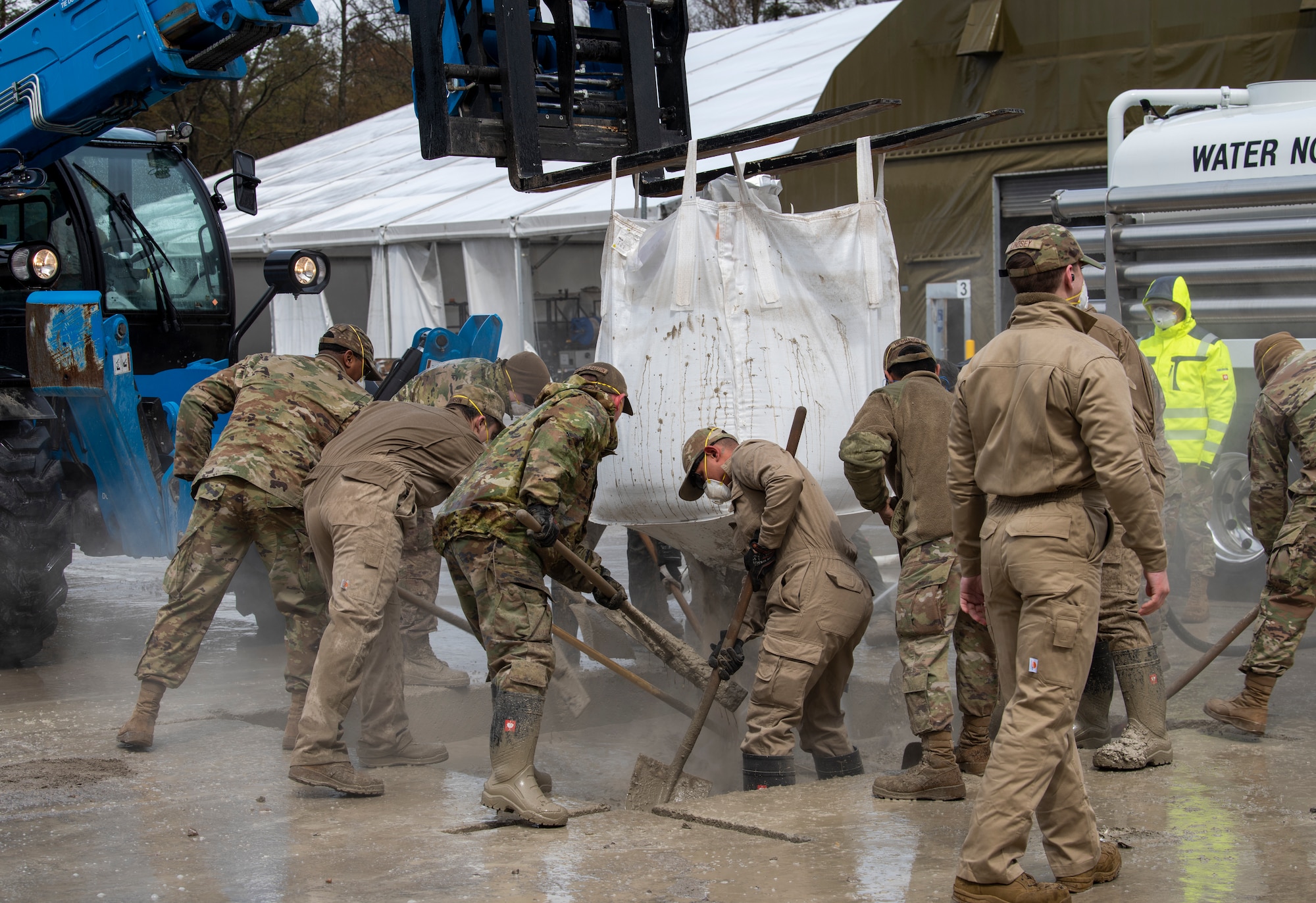 U.S. Air Force Airmen from the 86th Civil Engineer Squadron fill a crater with flowable fill during a Rapid Airfield Damage Recovery training at Ramstein Air Base, Germany, April 11, 2023.