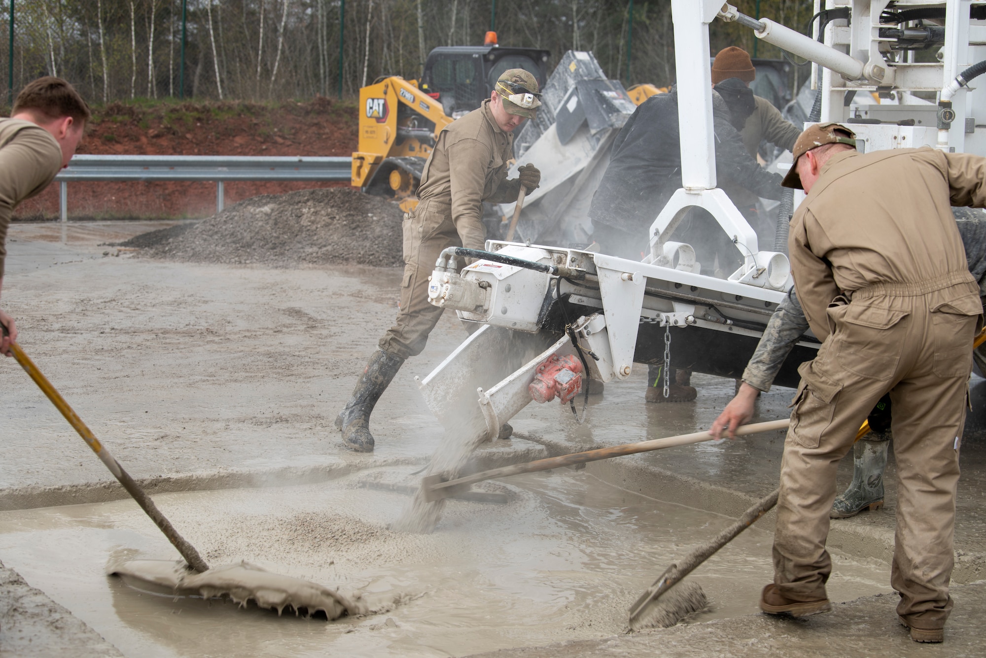 U.S. Air Force Airmen from the 86th Civil Engineer Squadron fill a crater with rapid set concrete during a Rapid Airfield Damage Recovery training at Ramstein Air Base, Germany, April 11, 2023.