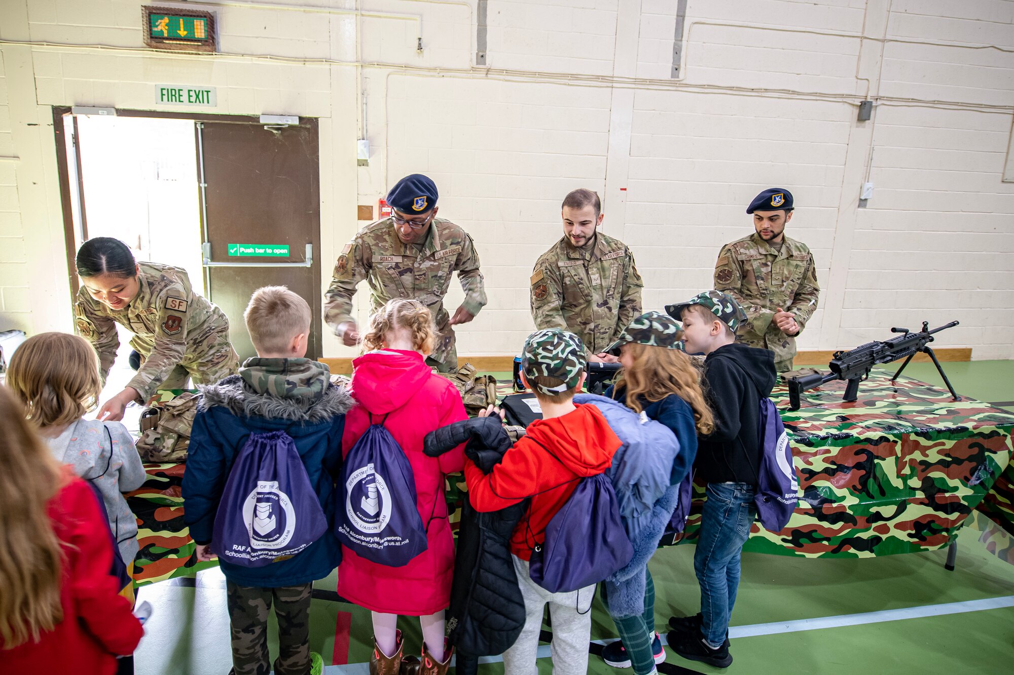 Airmen from the 423d Security Forces Squadron speak with Alconbury Elementary school students during Camp Kudos at RAF Alconbury, England, April 14, 2023. The camp gave students the opportunity to experience and learn about various aspects of deployment preparation and the wing mission. (U.S. Air Force photo by Staff Sgt. Eugene Oliver)