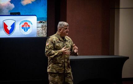 Soldier speaking on stage.