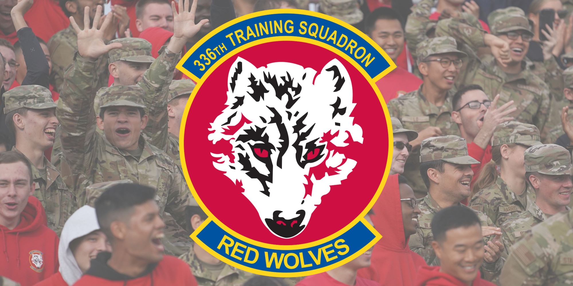 Graphic with the 336th Training Squadron Red Wolves logo imposed over a photo of 336th TRS students cheering.