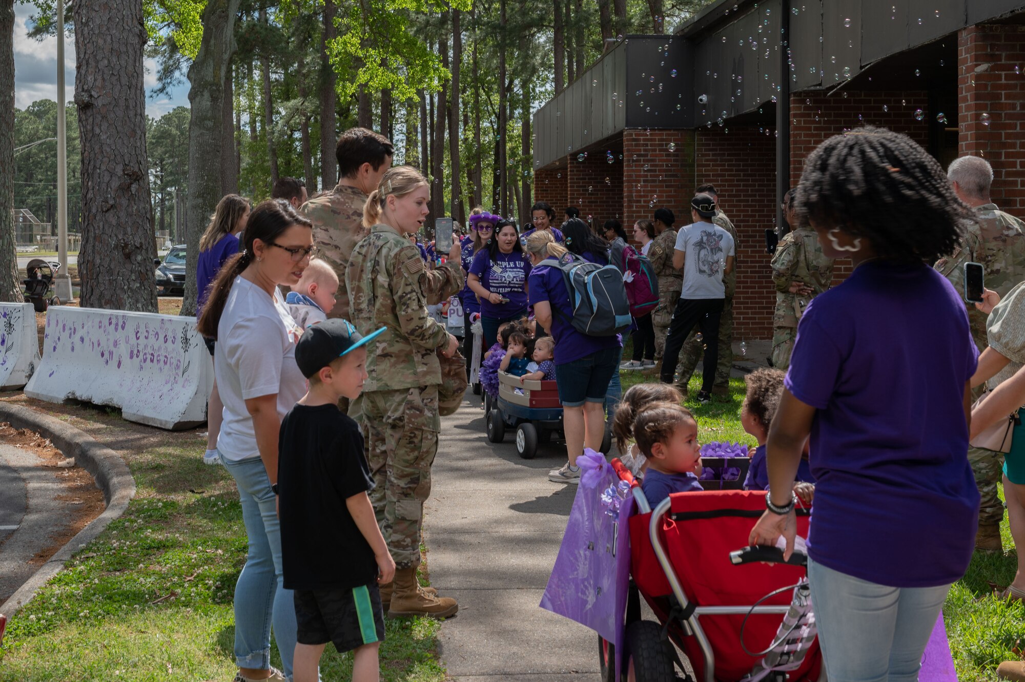 Children and teachers from the 4th Force Support Squadron Child Development Center march in the Purple Up Parade to recognize the Month of the Military Child at Seymour Johnson Air Force Base, North Carolina, April 14, 2023. April is designated as Month of the Military Child, signifying how important role that military children are to the armed forces community. (U.S. Air Force photo by Rebecca Sirimarco-Lang)