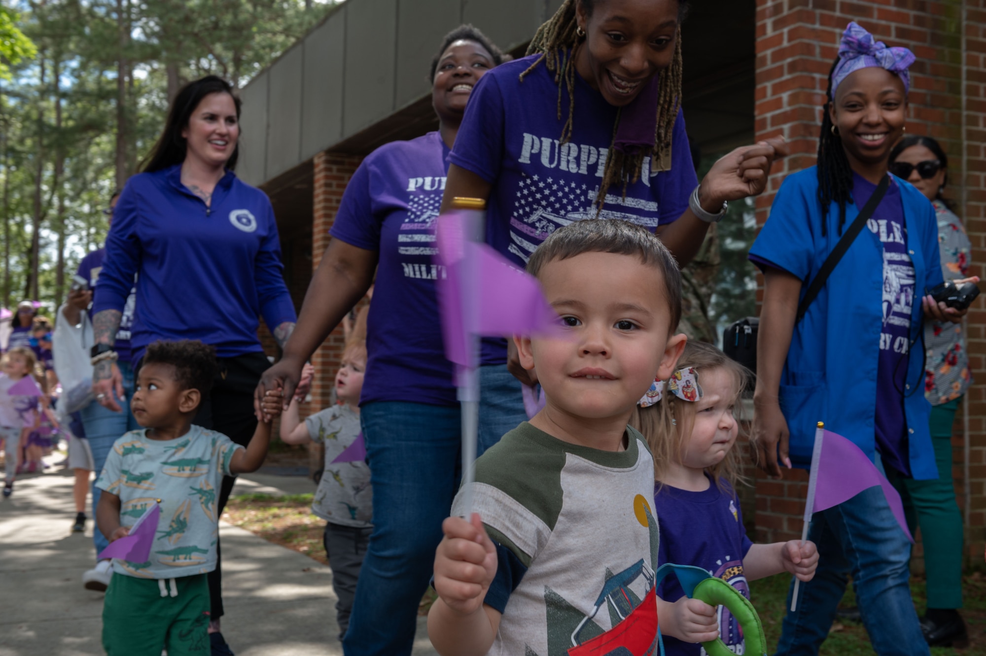 Children and teachers from the 4th Support Squadron Child Development Center march in the Purple Up Parade to recognize the Month of the Military Child at Seymour Johnson Air Force Base, North Carolina, April 14, 2023. Children and teachers wear purple as a visible way to show support and solidarity with military children. (U.S. Air Force photo by Rebecca Sirimarco-Lang)