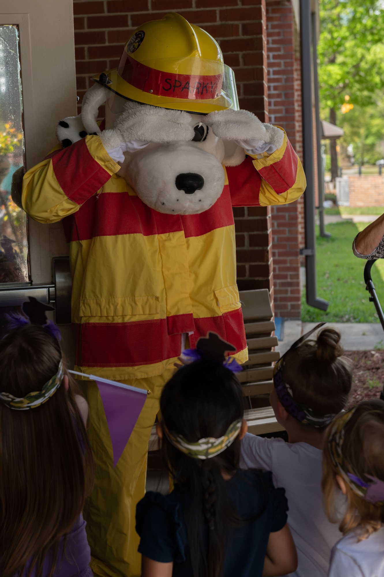 Children play with Sparky during the Purple Up parade Military Child as part of the Month of the Military Child at Seymour Johnson Air Force Base, North Carolina, April 14, 2023. The military community celebrates Month of the Military Child in April and places an emphasis on the strength of military member’s children as their parent serve home and overseas. (U.S. Air Force photo by Rebecca Sirimarco-Lang)