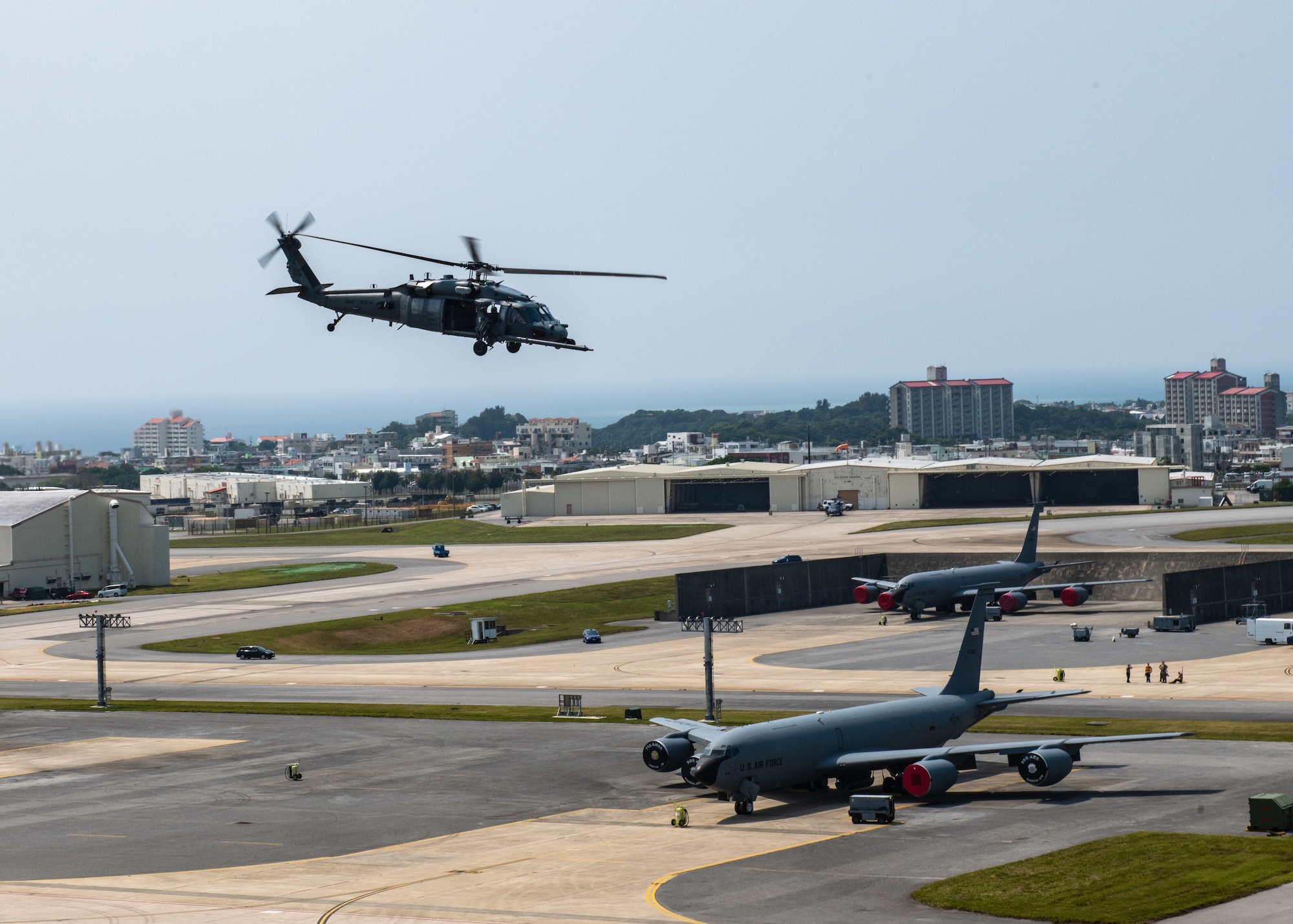 A helicopter flies over a military base.