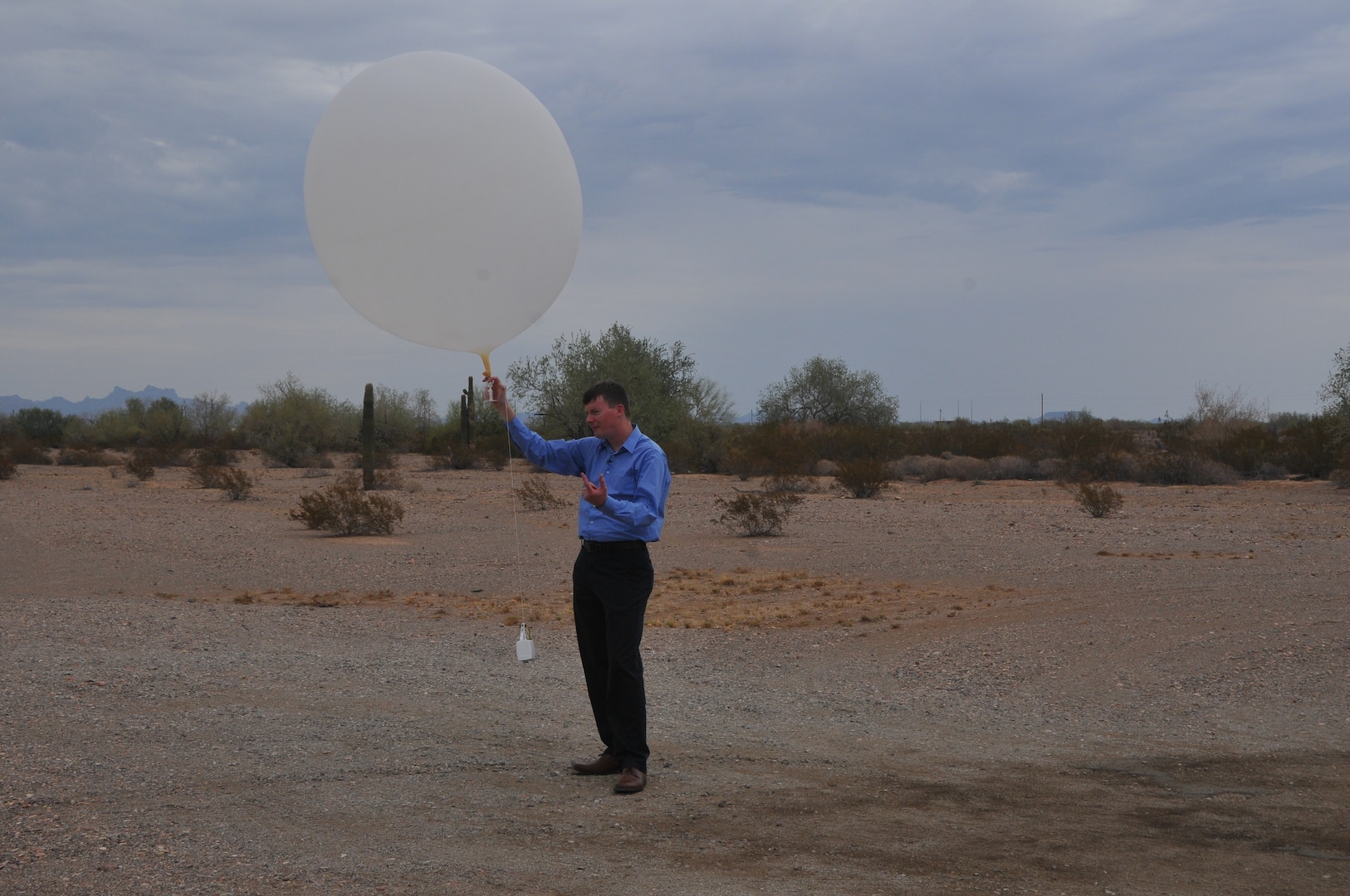 A man launches a balloon.