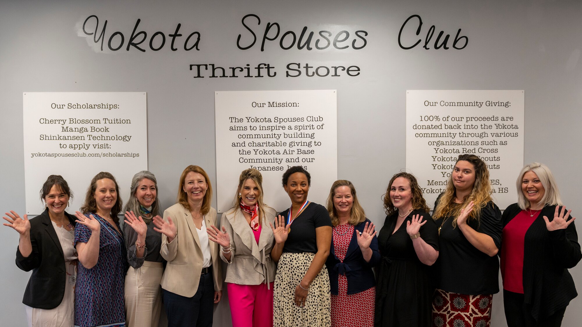 Cindy Wilsbach (center-left), First Lady of Pacific Air Forces, poses for a photo with the Yokota Spouses Club at the base thrift store during a site visit at Yokota Air Base, Japan, April 18, 2023.