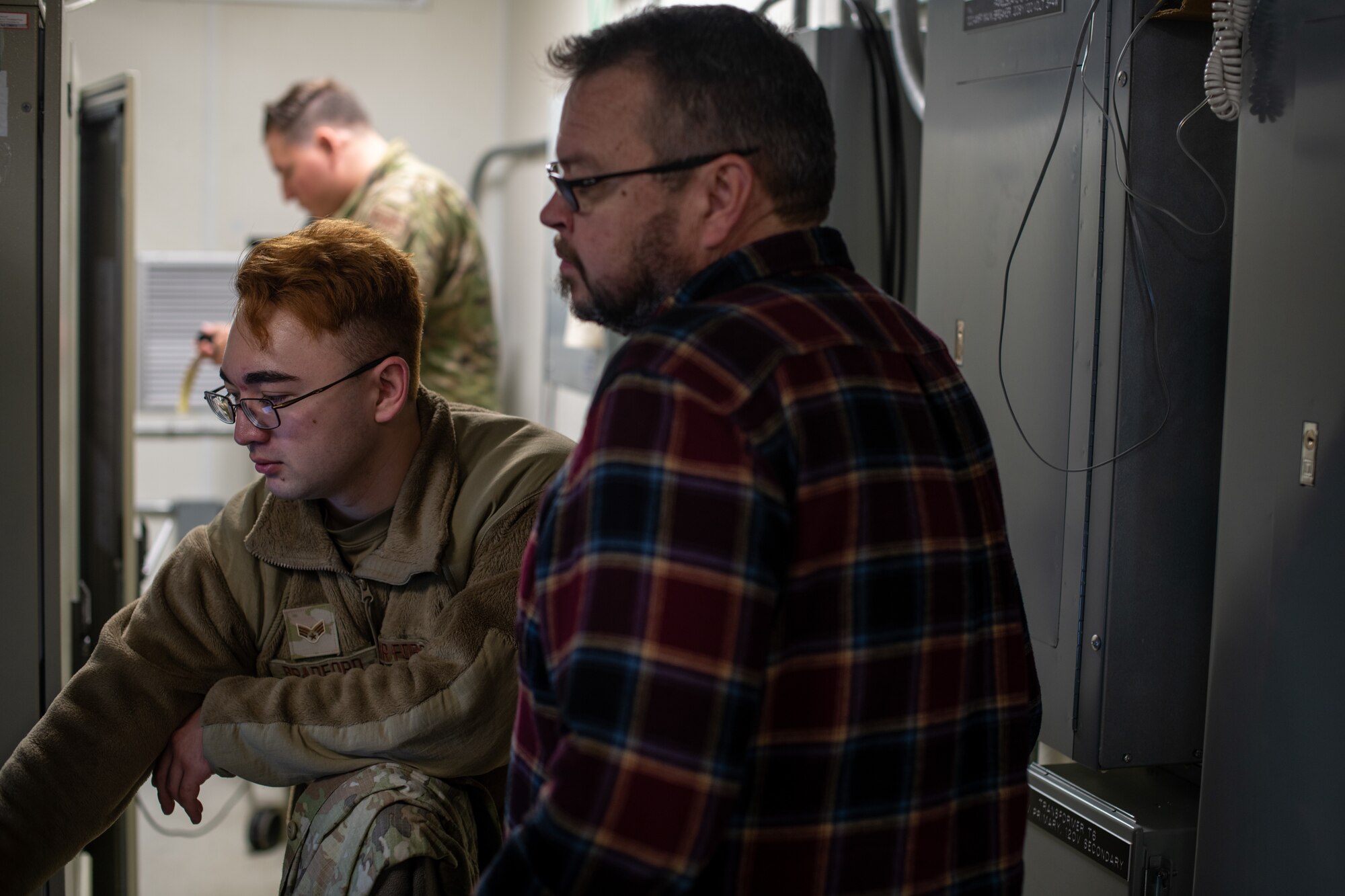 Senior Airman and Equipment Specialist ATC Radar going over radar data