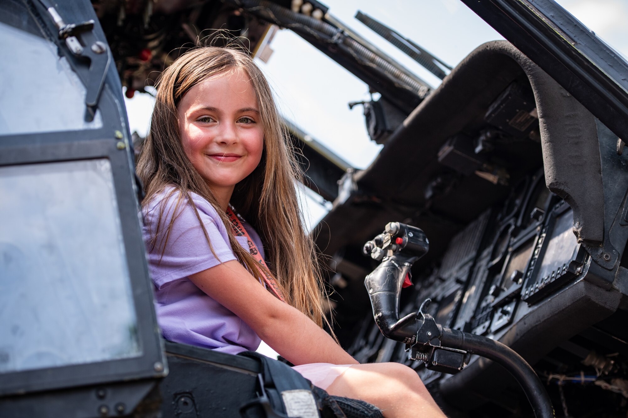 A child sits in a helicopter.