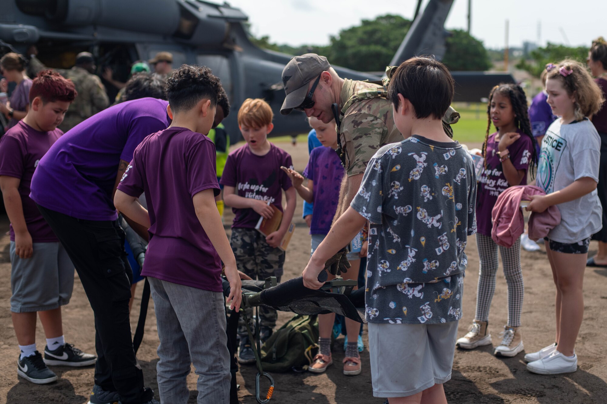 Kids learn how to use a stretcher.