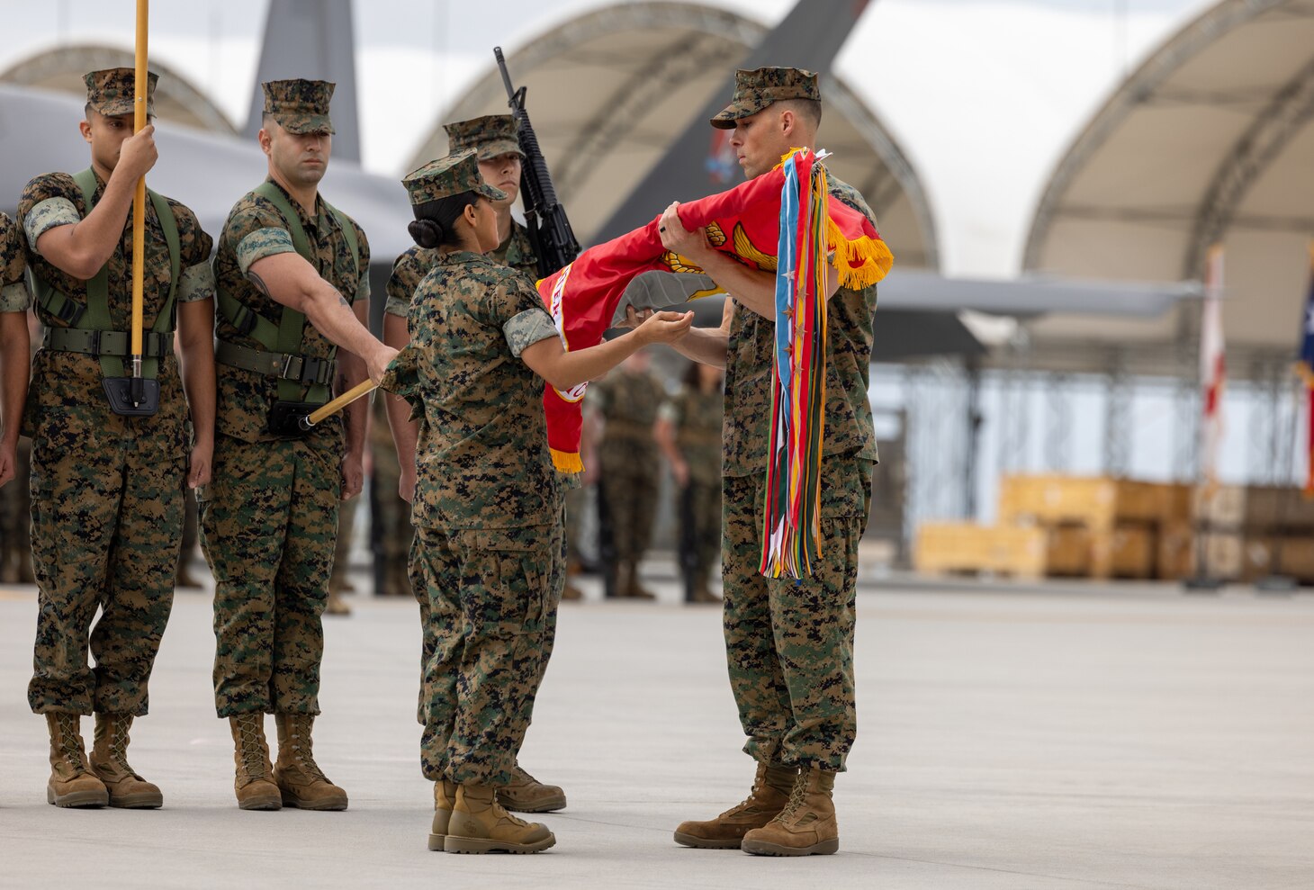 U.S. Marine Corps Sgt. Maj. Janet Marrufo and Lt. Col. Michael Fisher, both with Marine Fighter Attack Squadron 311, Marine Aircraft Group 11, 3rd Marine Aircraft Wing, unfurl the squadron colors during a reactivation ceremony at Marine Corps Air Station Miramar, California, April 14, 2023. The reactivation and redesignation of VMFA-311 marks the transition for the squadron to the F-35C Lightning II, which brings its unique capabilities to 3rd MAW as a long-range compliment to existing aviation assets. Formerly Marine Attack Squadron 311, the Tomcats have made their mark on Marine Corps aviation for decades, and now will continue their legacy.