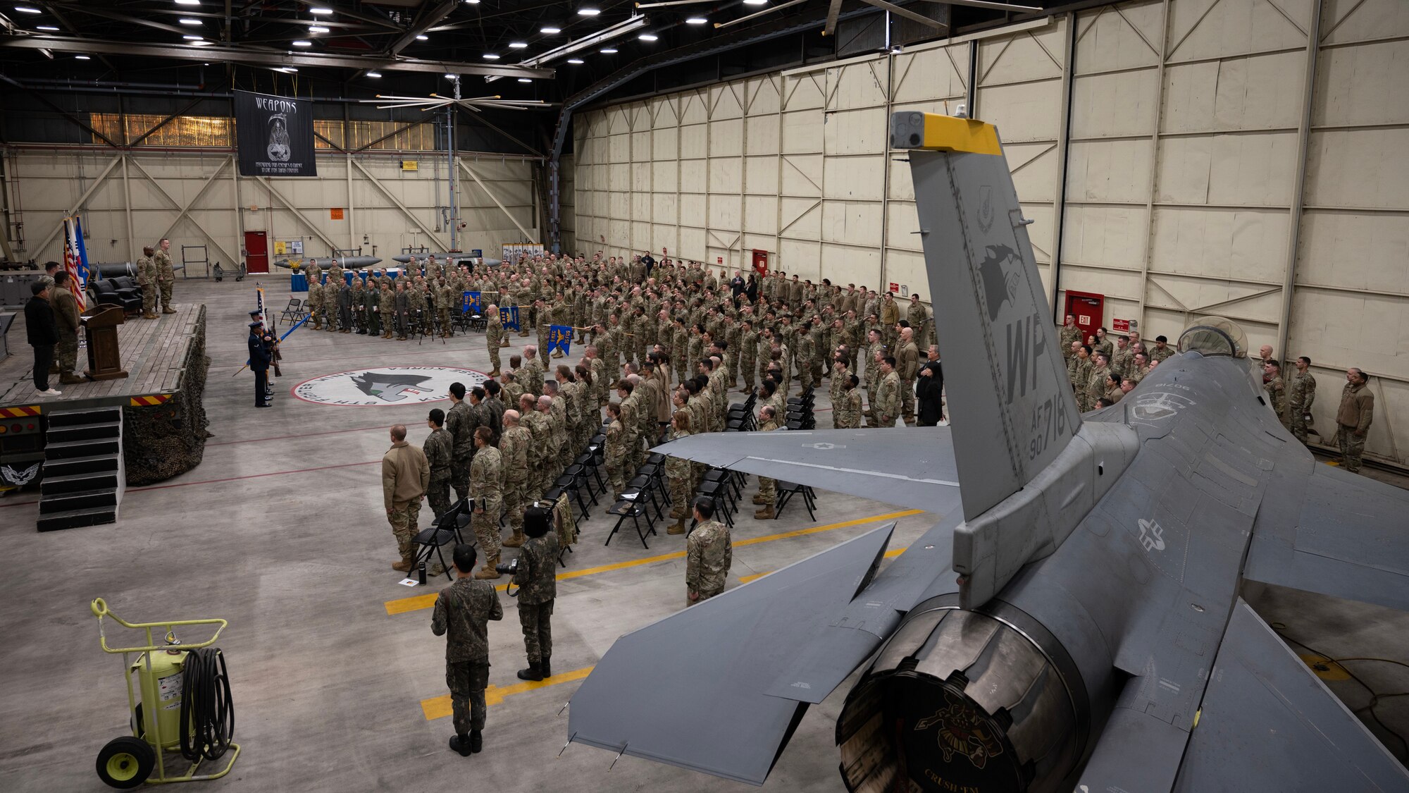 Airmen and civilians, stand for the Korean and American national anthem’s ahead of the 8th Maintenance Group assumption of command at Kunsan Air Base, Republic of Korea, Apr. 10, 2023.