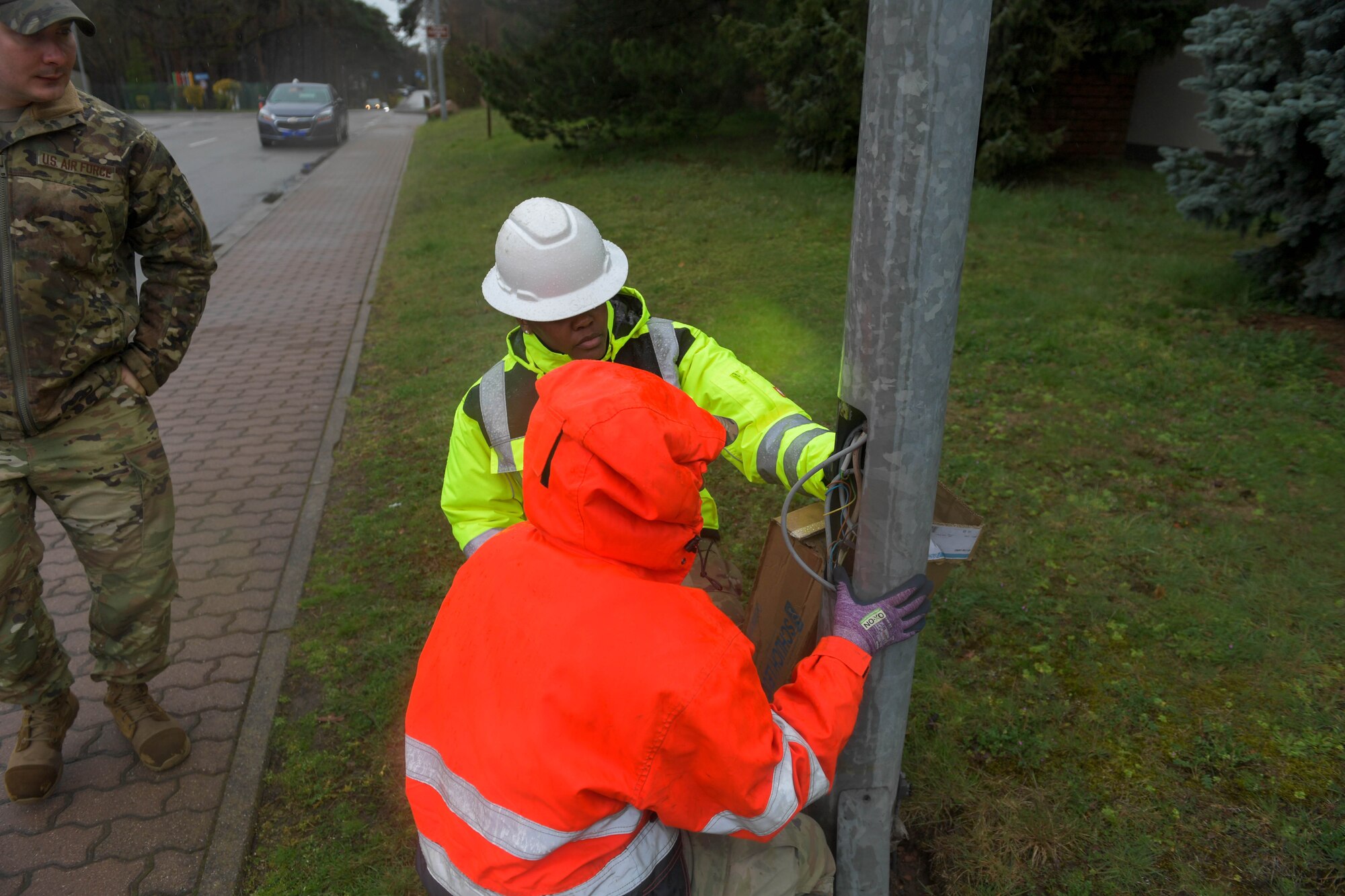 U.S. Air Force Airman 1st Class Dymond Mingua, 786th Civil Engineer Squadron electrical systems journeyman, shows Chief Master Sgt. Charmaine Kelly, 86th Airlift Wing command chief, the wiring of a streetlight at Ramstein Air Base, Germany, April 12, 2023. Mingua explained the process of regularly checking for wiring hazards, as well as the prevention of fire or an electrical shock while maintaining electrical systems.