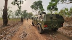 Staff Sgt. Alex Radi, 817th Engineer Company (Sapper), assists Benin Soldiers conducting a counter-IED mission in Ouassa, Benin, Feb. 16, 2023. The North Dakota National Guard Soldier worked with the Benin Soldiers to plan a practical exercise that incorporated counter-IED mission planning during mounted and dismounted patrols.