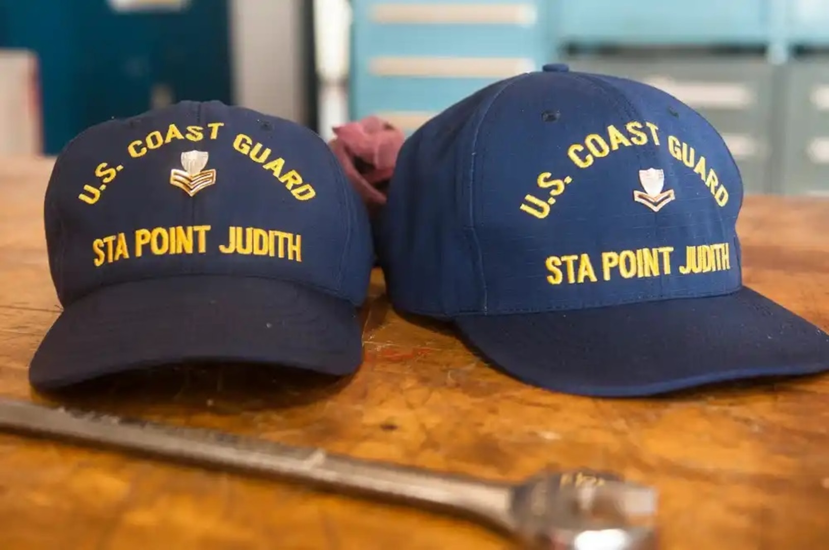 New insignia for Coast Guard covers lay pinned on a work bench after an advancement ceremony at Station Point Judith in Narragansett, R.I., Sept. 2, 2015. Petty Officer 1st Class Will Mudloff and Petty Officer 2nd Class Alan Freedman were advanced to their next respective pay grade. (U.S. Coast Guard photo by Petty Officer 3rd Class Ross Ruddell)