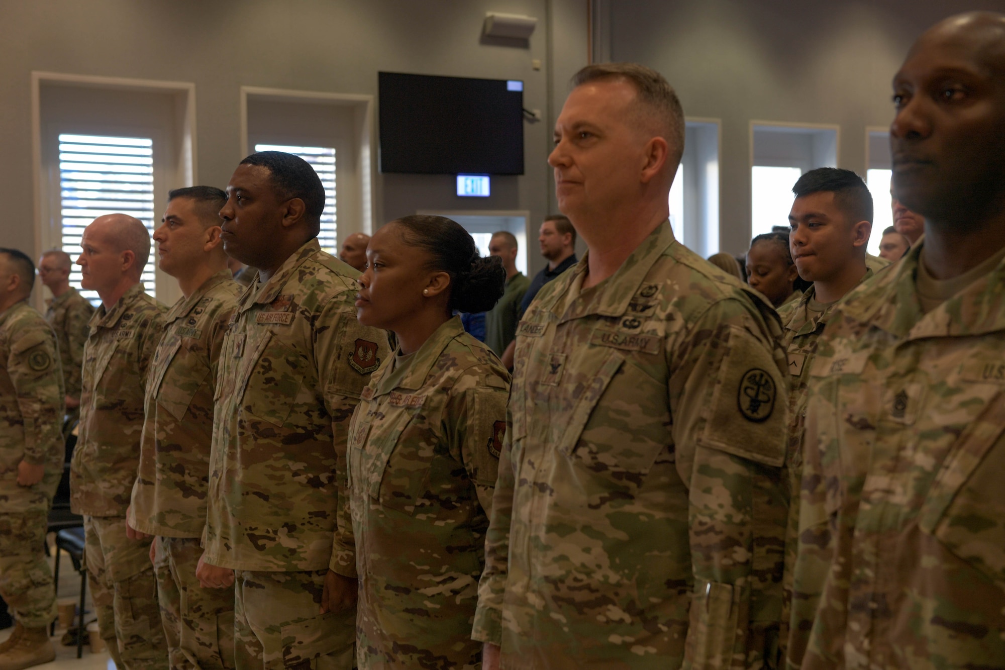 Leadership from Landstuhl Regional Medical Center and Ramstein Air Base, Germany, stand at attention while the U.S. and German national anthems play during a cake cutting ceremony at LMRC, April 14, 2023. The hospital has a long and proud history of providing medical care to military service members and their families.