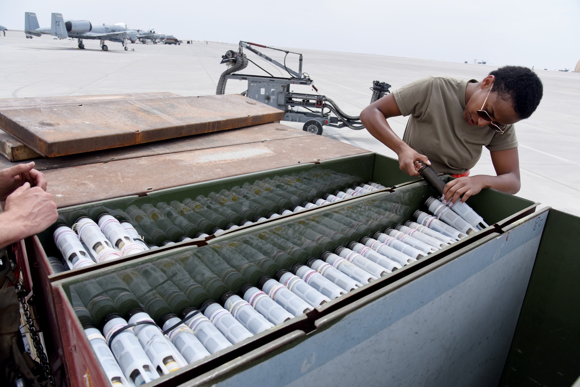 U.S. Air Force Airman First Class Fasika Robinson, 75th Expeditionary Fighter Generation Squadron weapons loader, prepares to load 30mm rounds into an A-10 Thunderbolt II in preparation for the first live-fire sortie out of Al Dhafra Air Base, United Arab Emirates, April 18, 2023. The loading of these munitions represents another step forward in the deployment of the A-10 to the U.S. Central Command area of responsibility, which offers the opportunity for 9th Air Force (Air Forces Central). to experiment with CAS capabilities in order to achieve the most robust, diverse force possible. Ninth AF (AFCENT) is committed to ensuring security and stability alongside our partners in the U.S. Central Command area of responsibility. (U.S. Air Force photo by Tech. Sgt. Chris Jacobs/released)