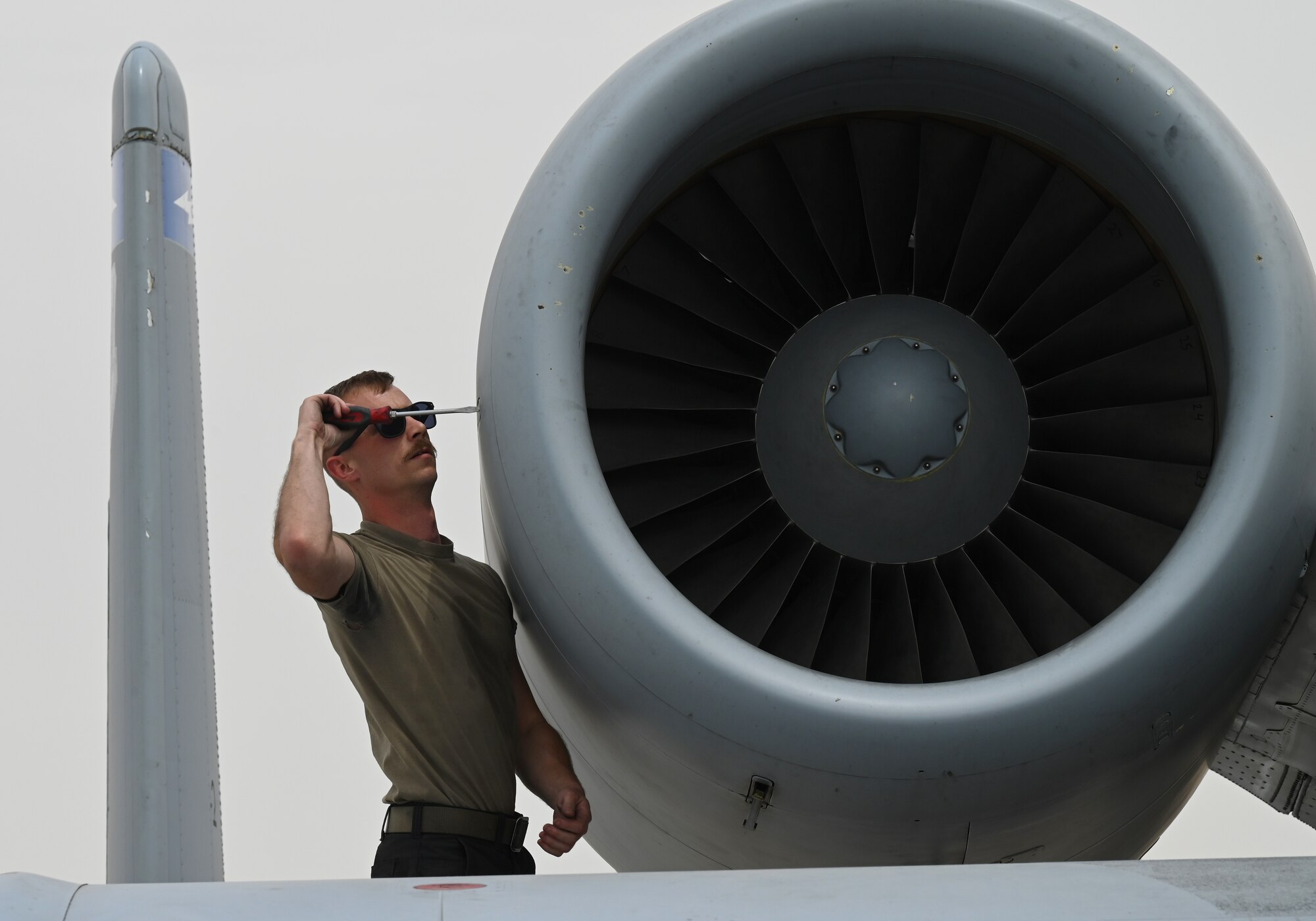 U.S. Air Force Staff Sgt. Kori Rennecker, 75th Expeditionary Fighter Generation Squadron aerospace propulsion craftsman, removes an engine panel on a U.S. Air Force A-10 Thunderbolt II at Al Dhafra Air Base, United Arab Emirates, April 18, 2022. The deployment of A-10s provides additional capability in tandem with other fighter aircraft throughout the region. (U.S. Air Force photo by Tech. Sgt. Alex Fox Echols III)