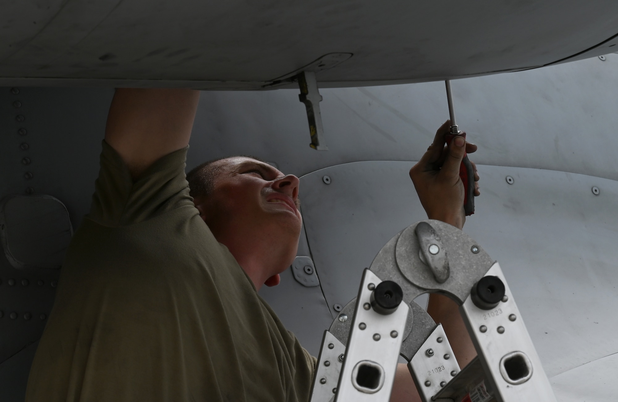 U.S. Air Force Airman 1st Class Michael Naber, 75th Expeditionary Fighter Generation Squadron aerospace propulsion journeyman, removes an engine panel on a U.S. Air Force A-10 Thunderbolt II at Al Dhafra Air Base, United Arab Emirates, April 18, 2022. The deployment of A-10s in the region provides additional capability in the Middle East alongside fighter aircraft. Ninth Air Force (U.S. Air Forces Central) is committed to ensuring security and stability alongside our partners in the U.S. Central Command area of responsibility. (U.S. Air Force photo by Tech. Sgt. Alex Fox Echols III)