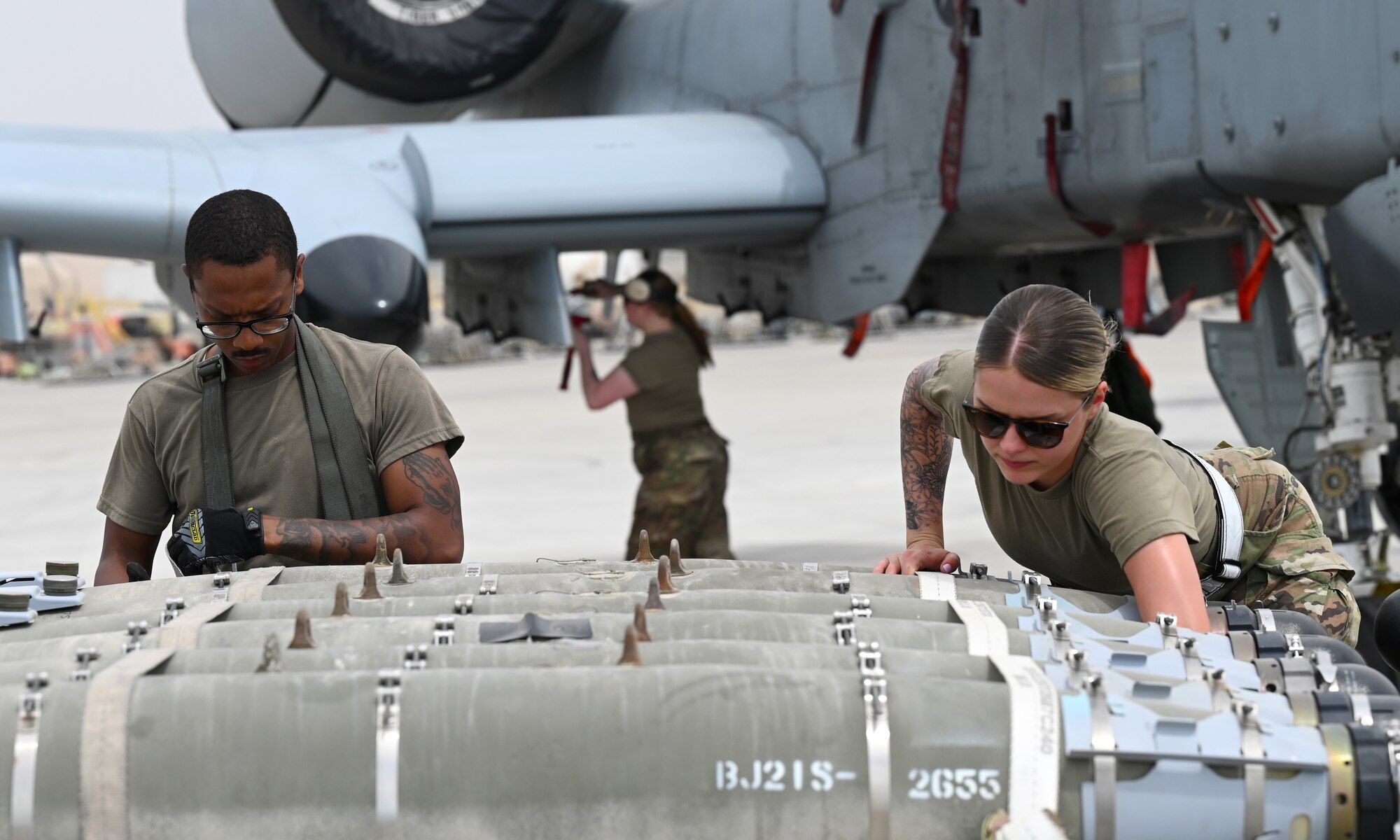 U.S. Air Force Staff Sgt. Brian Dorsey and Senior Airman Reese Deandrea, 75th Expeditionary Fighter Generation Squadron, squadron lead crew chief and member, prepare munitions to be loaded onto a U.S. Air Force A-10 Thunderbolt II at Al Dhafra Air Base, United Arab Emirates, April 18, 2022. The loading of these munitions represents another step forward in the deployment of the A-10 to the U.S. Central Command area of responsibility, which offers the opportunity for 9th Air Force (Air Forces Central). to experiment with CAS capabilities in order to achieve the most robust, diverse force possible. Ninth AF (AFCENT) is committed to ensuring security and stability alongside our partners in the U.S. Central Command area of responsibility. (U.S. Air Force photo by Tech. Sgt. Alex Fox Echols III)