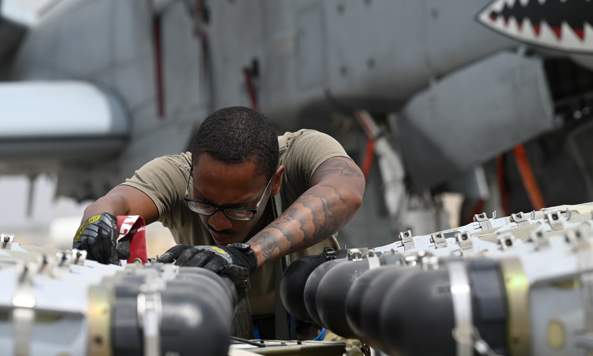 U.S. Air Force Staff Sgt. Brian Dorsey, 75th Expeditionary Fighter Generation Squadron squadron lead crew chief, prepares munitions to be loaded onto a U.S. Air Force A-10 Thunderbolt II at Al Dhafra Air Base, United Arab Emirates, April 18, 2022. The loading of these munitions represents another step forward in the deployment of the A-10 to the U.S. Central Command area of responsibility, which offers the opportunity for 9th Air Force (Air Forces Central). to experiment with CAS capabilities in order to achieve the most robust, diverse force possible. Ninth AF (AFCENT) is committed to ensuring security and stability alongside our partners in the U.S. Central Command area of responsibility. (U.S. Air Force photo by Tech. Sgt. Alex Fox Echols III)