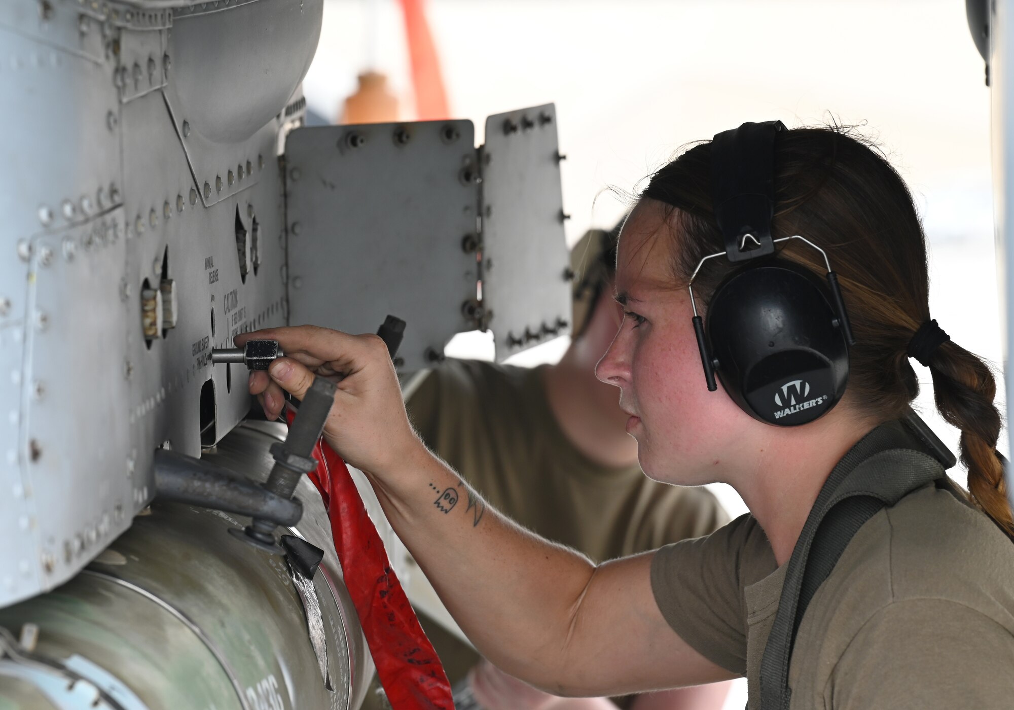 U.S. Air Force Staff Sgt. Journey Yanzick, 75th Expeditionary Fighter Generation Squadron weapons crew member, secures munitions onto a U.S. Air Force A-10 Thunderbolt II at Al Dhafra Air Base, United Arab Emirates, April 18, 2022. The loading of these munitions represents another step forward in the deployment of the A-10 to the U.S. Central Command area of responsibility, which offers the opportunity for 9th Air Force (Air Forces Central). to experiment with CAS capabilities in order to achieve the most robust, diverse force possible. Ninth AF (AFCENT) is committed to ensuring security and stability alongside our partners in the U.S. Central Command area of responsibility. (U.S. Air Force photo by Tech. Sgt. Alex Fox Echols III)