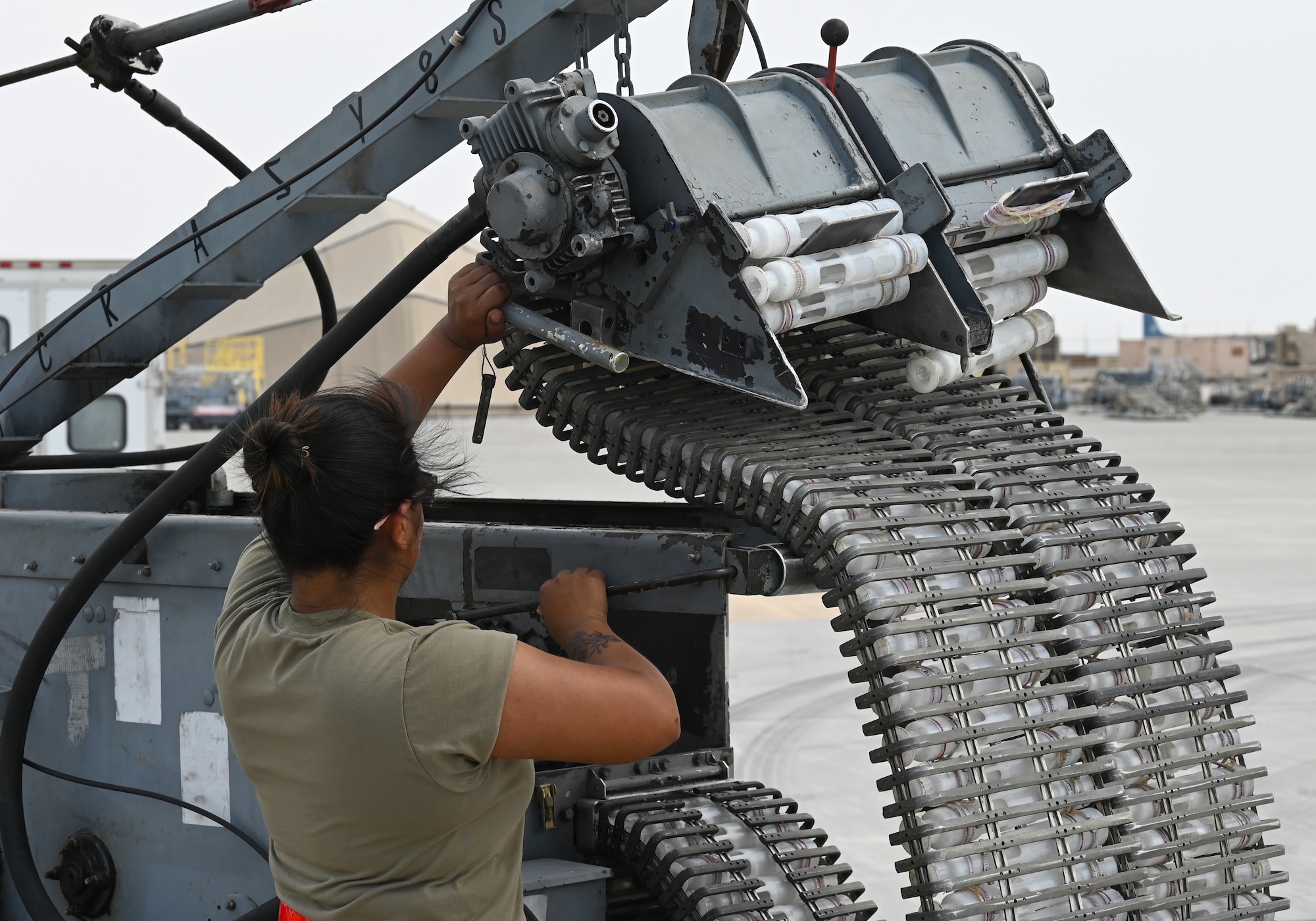 U.S. Air Force Airman 1st Class Serena Mena, 75th Expeditionary Fighter Generation Squadron weapons load crew member, prepares an ammunition loader prior to loading rounds into a U.S. Air Force A-10 Thunderbolt II at Al Dhafra Air Base, United Arab Emirates, April 18, 2022. The loading of these munitions represents another step forward in the deployment of the A-10 to the U.S. Central Command area of responsibility, which offers the opportunity for 9th Air Force (Air Forces Central). to experiment with CAS capabilities in order to achieve the most robust, diverse force possible. Ninth AF (AFCENT) is committed to ensuring security and stability alongside our partners in the U.S. Central Command area of responsibility. (U.S. Air Force photo by Tech. Sgt. Alex Fox Echols III)