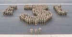 Naval Mobile Construction Battalion (NMCB) 3 posses in the shape of a three for a command photo, Mar. 16, 2023.