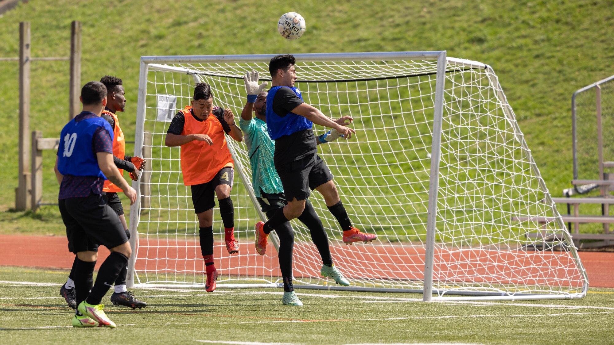 U.S. Marines and civilians with Marine Corps Base Quantico participate in the Marine Corps Intramural Flag Football game at Butler Stadium on Marine Corps Base Quantico, Virginia, Apr. 4, 2022.