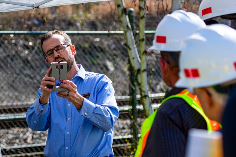 Chris Dening, a project manager for the U.S. Army Corps of Engineers Pittsburgh District, shows a model of a wall crack while briefing an upcoming construction project to members of the Inland Waterways Users Board touring the Monongahela River Locks and Dam 4 at Charleroi, Pennsylvania, April 12, 2023.

The U.S. Army Corps of Engineers Pittsburgh District hosted the tour and several briefings about ongoing and future inland navigation construction projects within the district.

During the tour, Inland Waterways User Board (IWUB) members learned about the overall Lower Monongahela River navigation project and the new river chamber construction at Charleroi, which is in its final phase after nearly 20 years of construction. Members also listened to briefings about the overall Upper Ohio navigation project and its first major construction contract, the new Montgomery lock construction. 

IWUB is an industry federal-advisory committee representing all fuel-taxed inland waterway systems within the United States. The navigation industry contributes to the Inland Waterways Trust Fund through fuel taxes paid by carriers who transport bulk commodities on the inland waterway system. The board makes recommendations to Congress and the Assistant Secretary of the Army for Civil Works on how best to invest federal and trust funds dollars to keep the most cost-effective, environmentally friendly, and safest form of transportation for bulk commodities resilient and reliable.
(U.S. Army Corps of Engineers Pittsburgh District photo by Michel Sauret)