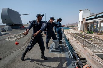 Culinary Specialist Seaman Adam Collins throws heaving line on the foc'scle of the guided-missile destroyer USS Paul Hamilton (DDG 60), April 10, 2023 in the Port of Eilat, Israel.