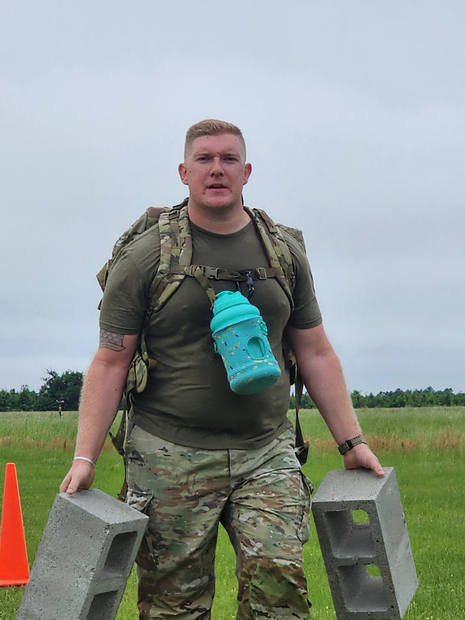 U.S. Air Force Staff Sgt. Kyle Jester, 23rd Security Forces Squadron training manager, carries two cinder blocks during an annual Bataan Death March in Lowndes County, Georgia, April 8, 2023. The march is a reminder of the hardships and sacrifices endured by the prisoners of war during the Battle of Bataan in April of 1942. (U.S. Air Force courtesy photo)