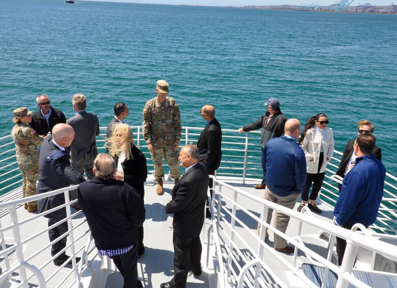 The incoming U.S. Army Corps of Engineers Los Angeles commander, Col. Andrew Baker, center, and senior members of the district team discuss widening and deepening ship lanes with Port of Long Beach officials April 3 during a seaborne port excursion off the coast of Long Beach, California. Baker is slated to assume command of the district in July when Col. Julie Balten’s three-year assignment is complete.
