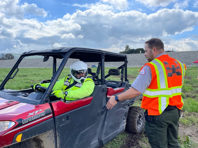 Frank Gonzalez, a member of the fence maintenance crew with the Los Angeles District’s Operations and Maintenance Branch, left, takes cues from Nicolas Figueroa, LA District park ranger, during utility terrain vehicle training March 23 at the Whittier Narrows Dam area of operations in Pico Rivera, California.