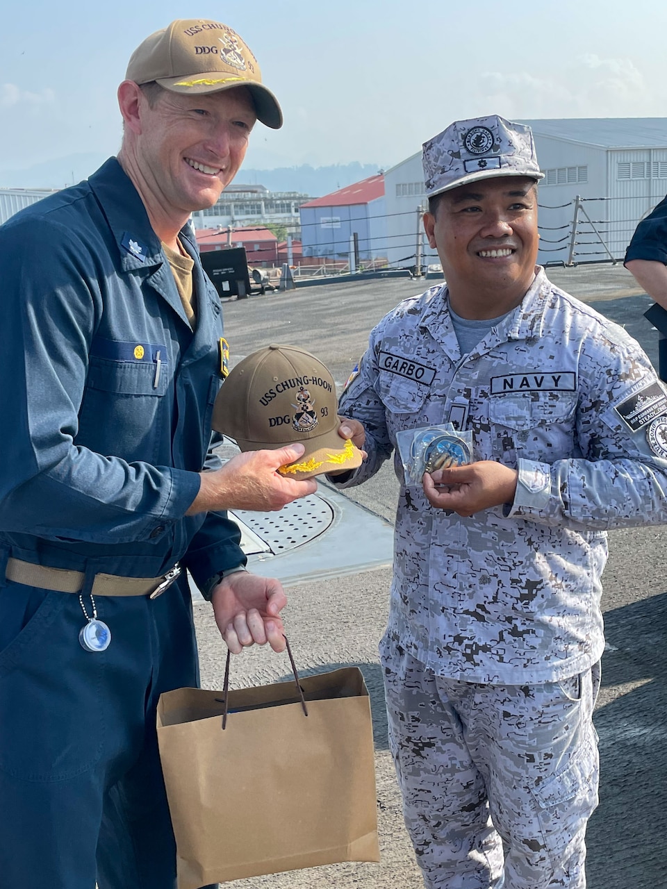 SUBIC BAY, Philippines (April 17, 2023) Commanding Officer of the Arleigh Burke-class guided-missile destroyer USS Chung-Hoon (DDG 93), Cmdr. Kevin Schaeffer exchanges gifts with Philippine Navy Operations Officer Lt. Cmdr. Randy Garbo assigned to the Phoang-class corvette BRP Conrado Yap (PS 39) aboard Chung-Hoon. USS Chung-Hoon is on a routine deployment to U.S. 7th Fleet and is assigned to Commander, Task Force (CTF 71)/ Destroyer Squadron (DESRON) 15. CTF 71/DESRON 15 is the largest forward-deployed DESRON and the U.S. 7th Fleet’s principal surface force. (U.S. Navy photo by Mass Communication Specialist 1st Class Andre T. Richard)