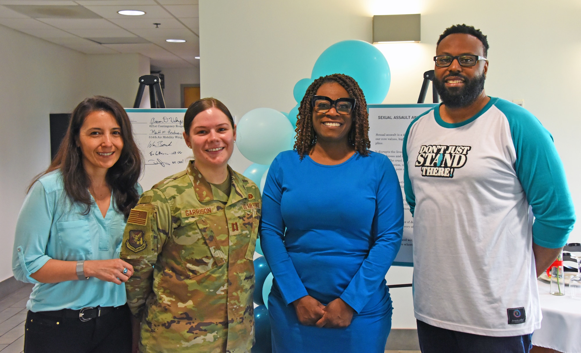 U.S. Air Force Capt. Leah Garrison, Sexual Assault Prevention and Response deputy sexual assault response coordinator, poses for a group photo with the SAPR team at the Sexual Assault Awareness and Prevention Month proclamation signing on Joint Base McGuire-Dix-Lakehurst, N.J., Apr. 6, 2023. The SAAPM proclamation signing is an event that Joint Base MDL leadership and members of the joint base community come together to promote the prevention of sexual violence and provide protection and support to the victims and survivors of interpersonal violence around the joint base. April is Sexual Assault Awareness and Prevention Month. Joint Base MDL observes this month by raising awareness to prevent sexual assault and harassment and to provide resources and victim support to educate the public. These efforts contribute to a safe and secure joint base community.  (U.S. Air Force photo by Daniel Barney)