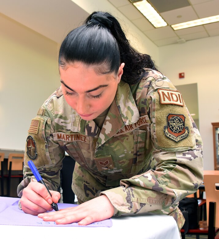 U.S. Air Force Senior Airman Alexis Martinez, 305th Maintenance Squadron non-destructive inspections specialist, decorates a bandana as part of the Clothesline of Healing event on Joint Base McGuire-Dix-Lakehurst, N.J., Apr. 12, 2023. The Clothesline of Healing is an event where members of the joint base community can decorate bandanas to show support for survivors and honor victims of interpersonal violence. April is Sexual Assault Awareness and Prevention Month. Joint Base MDL observes this month by raising awareness to prevent sexual assault and harassment and to provide resources and victim support to educate the public. These efforts contribute to a safe and secure joint base community. (U.S. Air Force photo by Daniel Barney)