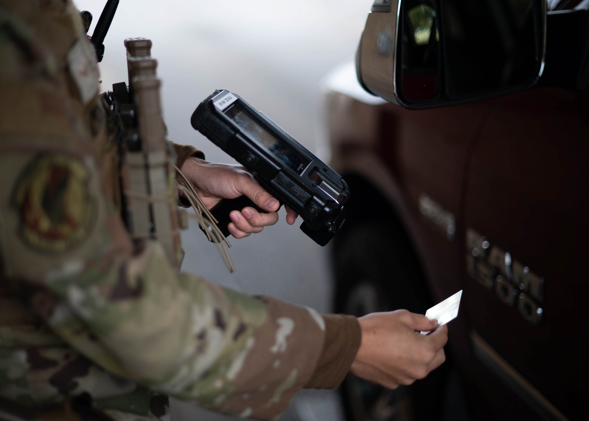 Security Forces Airmen scans ID card at front gate