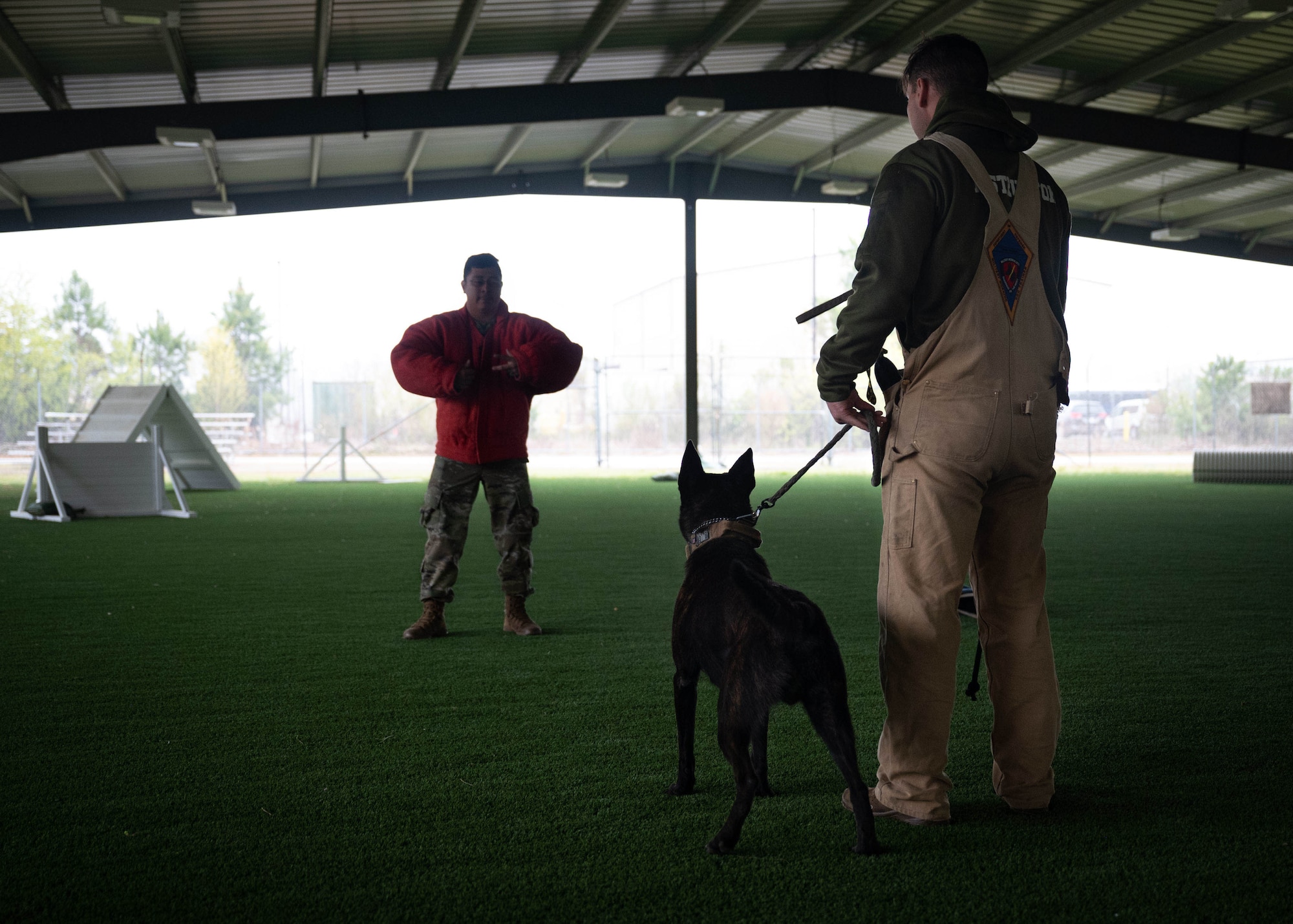Two Airmen perform Military Working Dog training