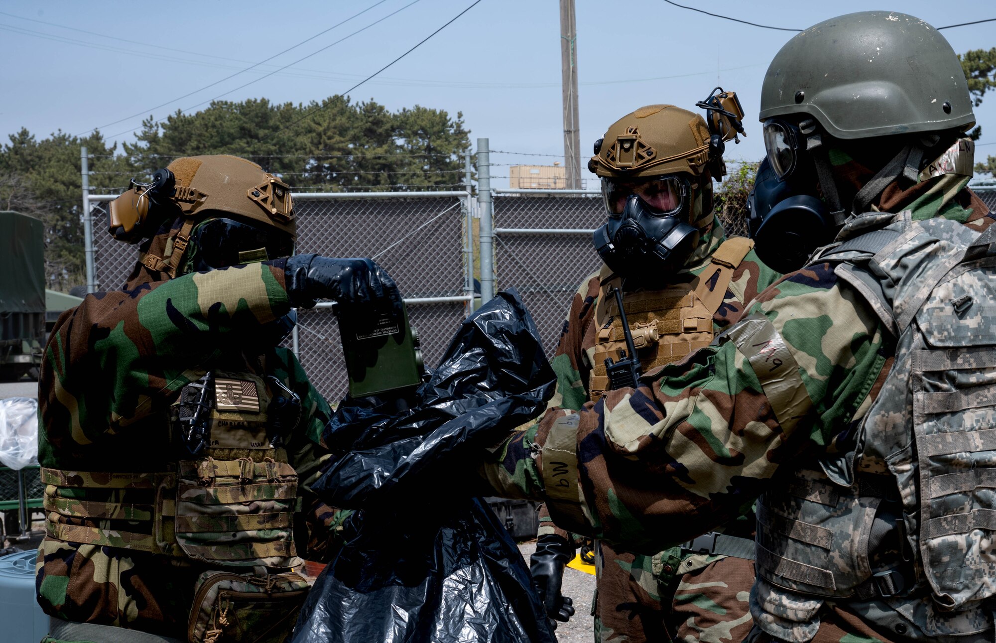 Senior Airman Charles James (left), 8th Civil Engineer Squadron explosive ordnance disposal technician, utilizes a joint chemical agent detector during a training event at Kunsan Air Base, Republic of Korea, April 20, 2023. A JCAD is used to detect the presence of chemical warfare agents and toxic industrial vapors. (U.S. Air Force photo illustration by Senior Airman Shannon Braaten)