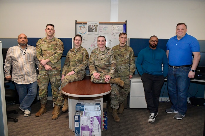 Team members and creators of a new electronic records management system pose for group photo. (Left to right) William Shrader, Staff Sgt. Jared Sylvester, Airman 1st Class Jenna Skinner, Senior Airman Brandon Tankersley, Senior Airman John Wright, Bryce Terry and Stanley Holmes, all 75th Air Base Wing, information and communications directorate. (US Photo by Todd Cromar)