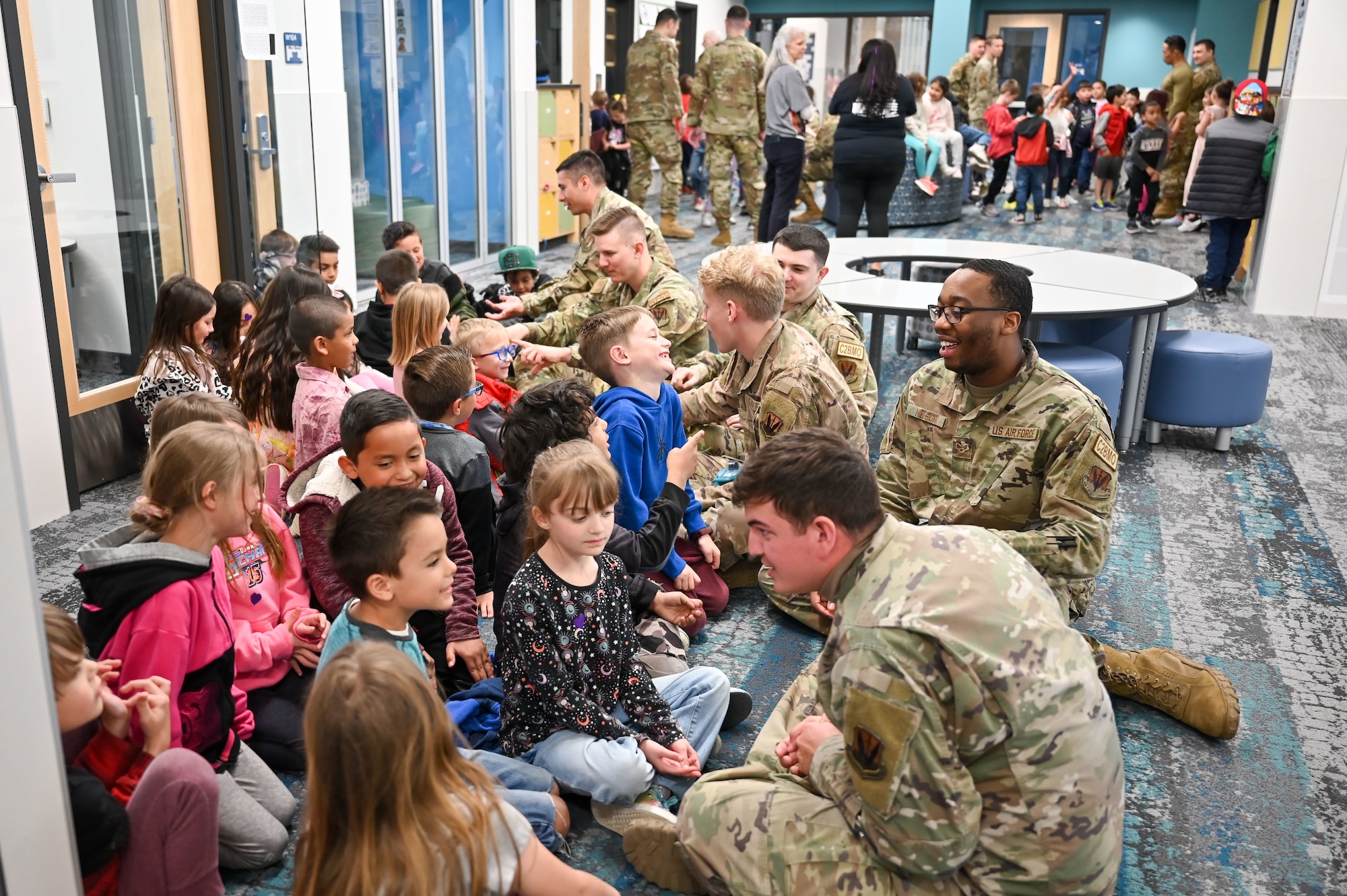 Airmen from Hill Air Force Base Airmen Leadership School chat with South Clearfield Elementary students April 18, 2023, in Clearfield, Utah. The Airmen visited the school to engage with the community during the Month of the Military Child. (U.S. Air Force photo by Cynthia Griggs)