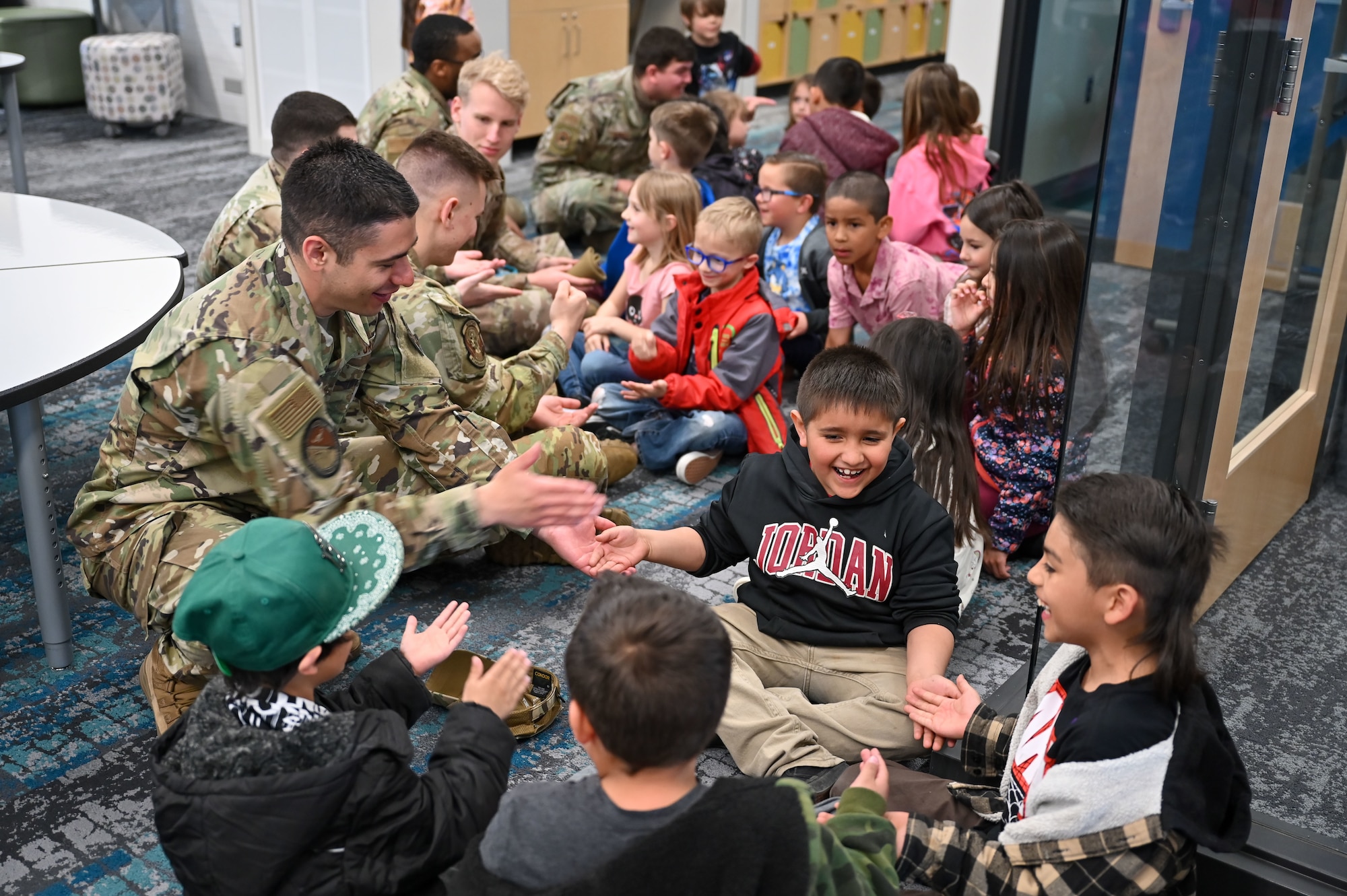 Airmen from Hill Air Force Base Airmen Leadership School play with South Clearfield Elementary students April 18, 2023, in Clearfield, Utah. The Airmen visited the school to engage with the community during the Month of the Military Child. (U.S. Air Force photo by Cynthia Griggs)