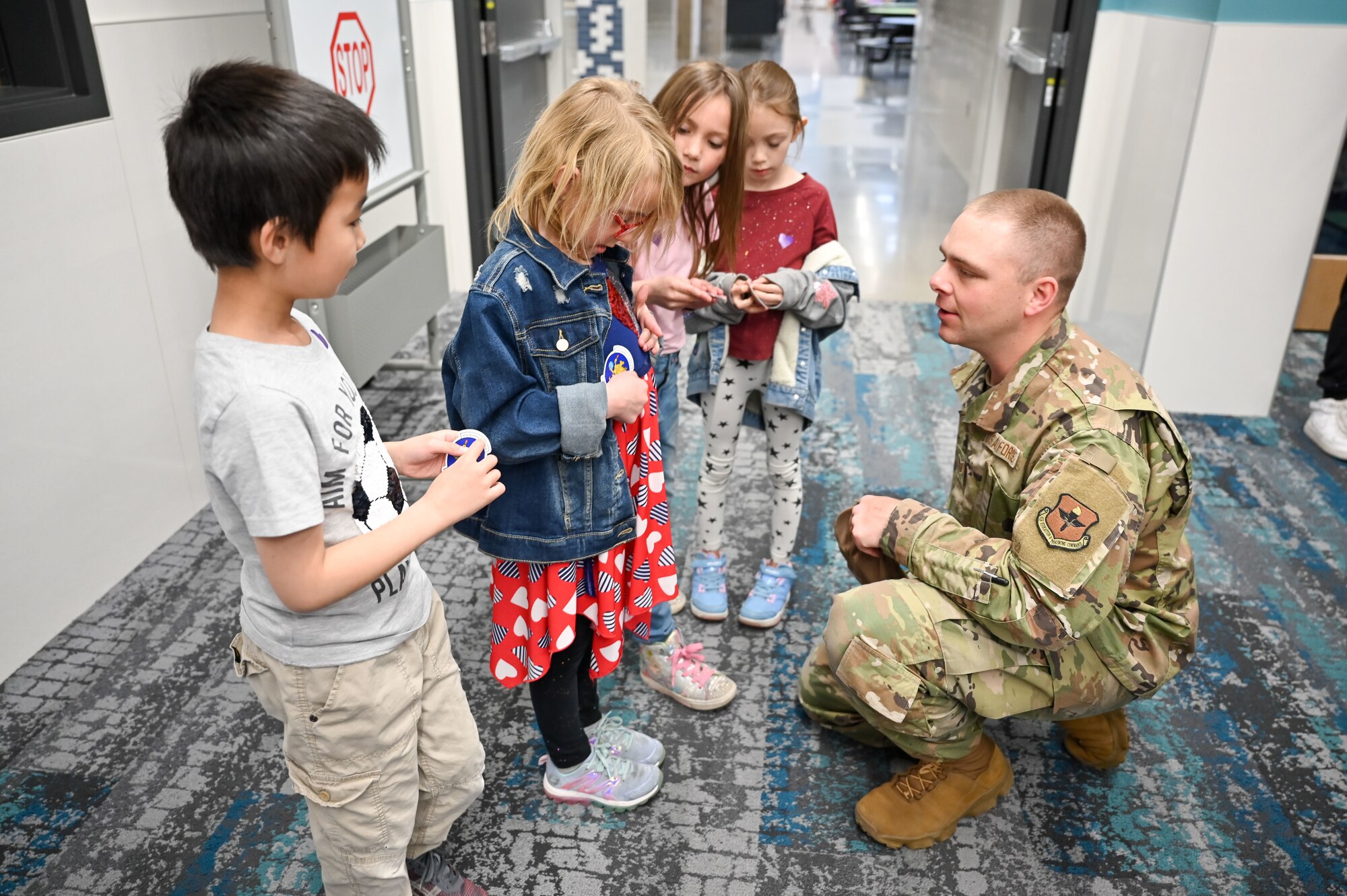 Technical Sgt. Nicholas Reider, 367th Training Support Squadron, chats with South Clearfield Elementary students April 18, 2023, in Clearfield, Utah. The Airmen visited the school to engage with the community during the Month of the Military Child. (U.S. Air Force photo by Cynthia Griggs)