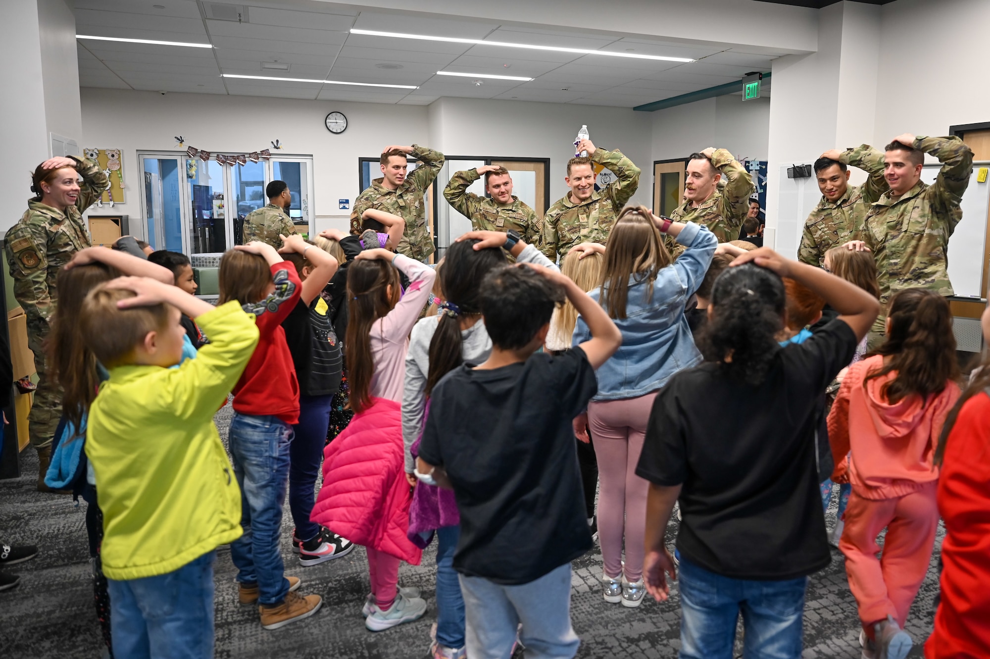 Airmen from Hill Air Force Base Airmen Leadership School play Simon Says with South Clearfield Elementary students April 18, 2023, in Clearfield, Utah. The Airmen visited the school to engage with the community during the Month of the Military Child. (U.S. Air Force photo by Cynthia Griggs)