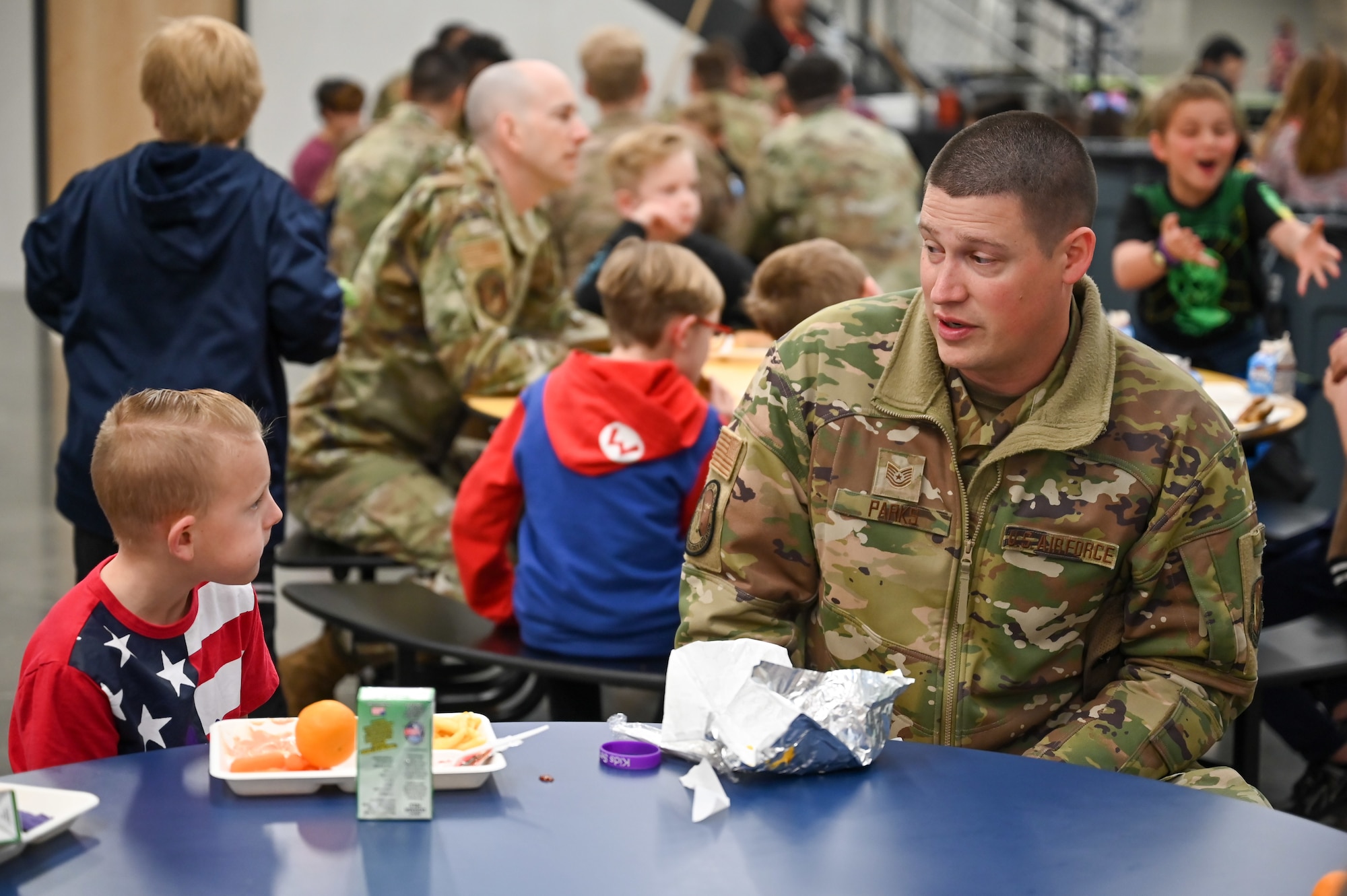 Technical Sgt. Garrett Parks, 75th Force Support Squadron, chats with a South Clearfield Elementary student April 18, 2023, in Clearfield, Utah. The Airmen visited the school to engage with the community during the Month of the Military Child. (U.S. Air Force photo by Cynthia Griggs)