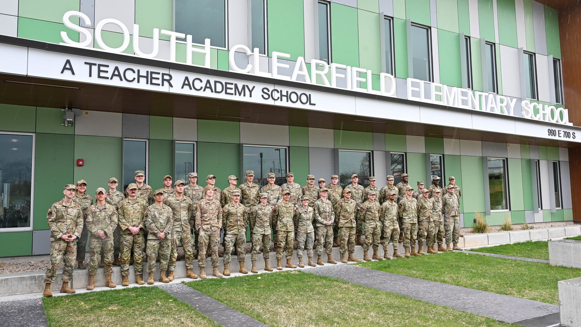 Airmen from Hill Air Force Base’s Airmen Leadership School pose in front of South Clearfield Elementary School April 18, 2023, in Clearfield, Utah. The Airmen visited the school to engage with the community during the Month of the Military Child. (U.S. Air Force photo by Cynthia Griggs)