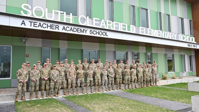 Airmen from Hill Air Force Base’s Airmen Leadership School pose in front of South Clearfield Elementary School April 18, 2023, in Clearfield, Utah. The Airmen visited the school to engage with the community during the Month of the Military Child. (U.S. Air Force photo by Cynthia Griggs)