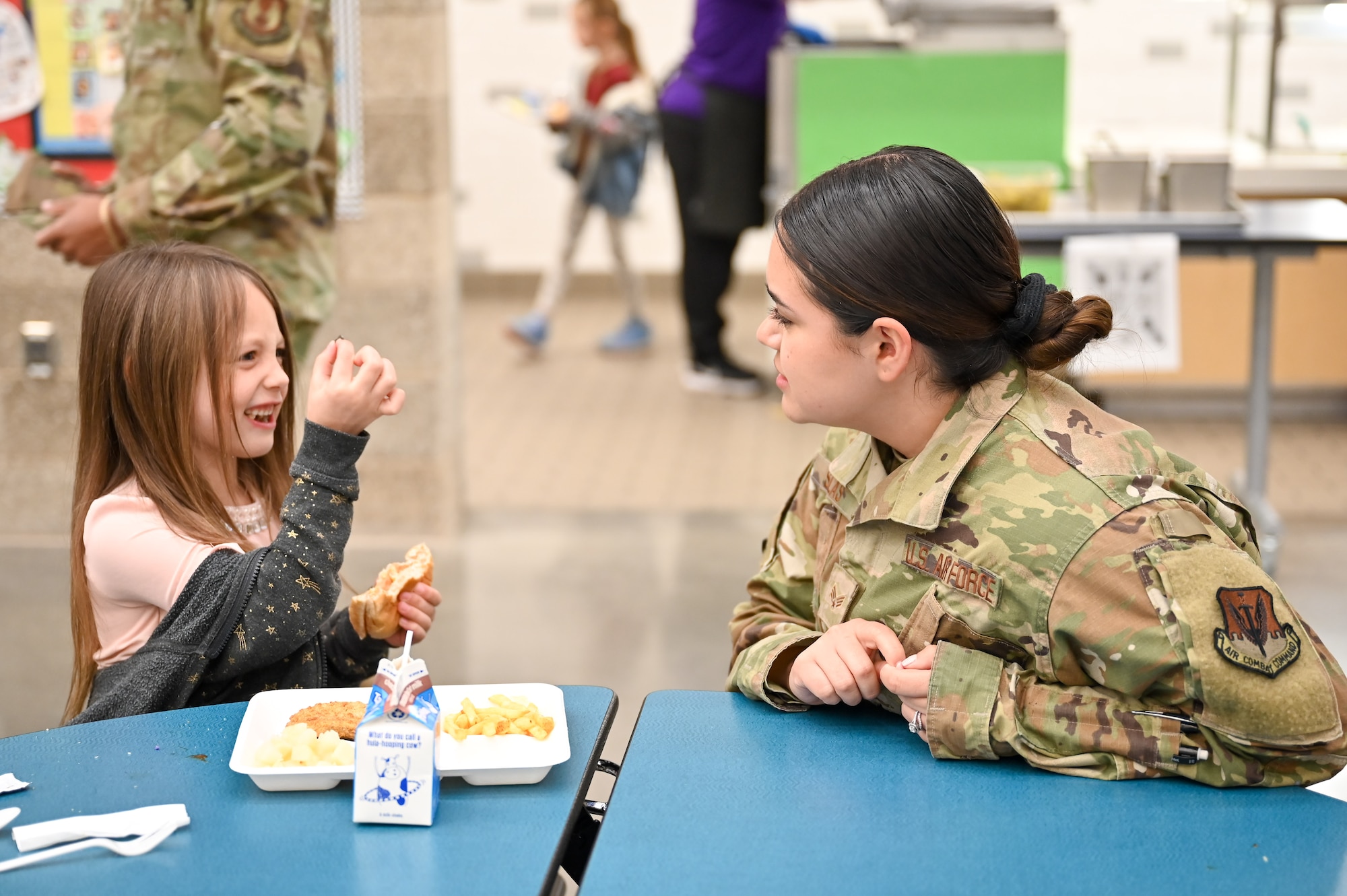 Senior Airman Clarissa Salas, 388th Logistics Support Squadron, chats with a South Clearfield Elementary student April 18, 2023, in Clearfield, Utah. The Airmen visited the school to engage with the community during the Month of the Military Child. (U.S. Air Force photo by Cynthia Griggs)